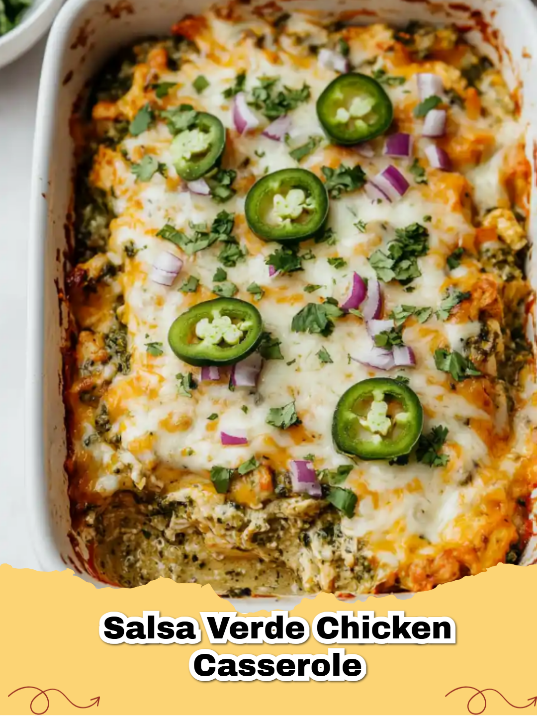 A bubbly and cheesy Easy Salsa Verde Chicken Casserole in a white baking dish.