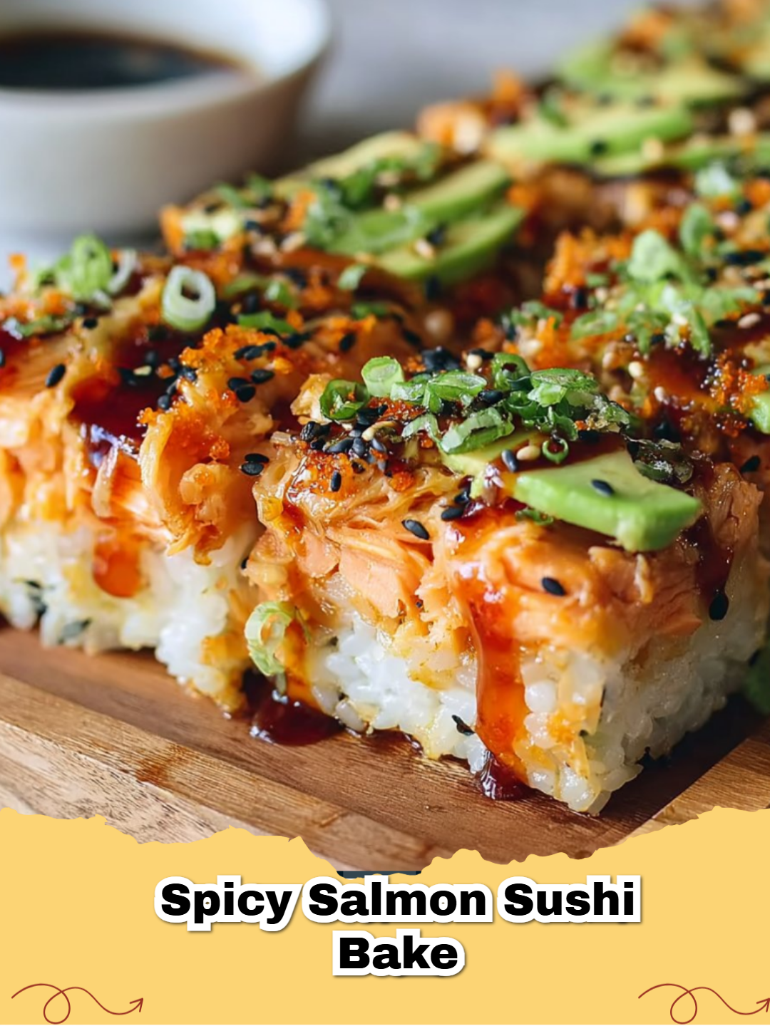 A tray of Easy Spicy Salmon Sushi Bake with green onions and nori strips.