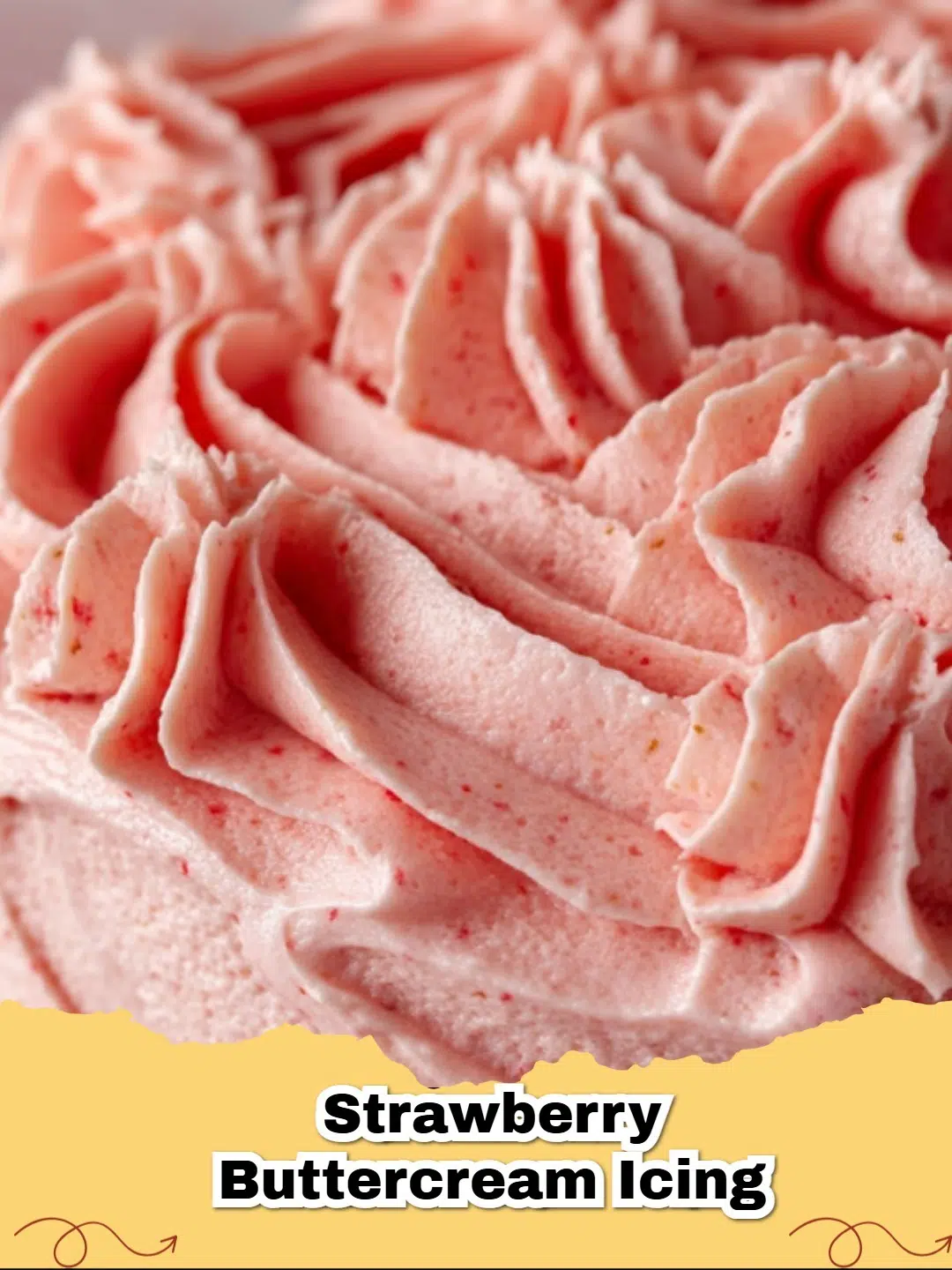 A close up of Fresh Strawberry Buttercream Frosting swirled on a vanilla cupcake with a fresh strawberry on top.