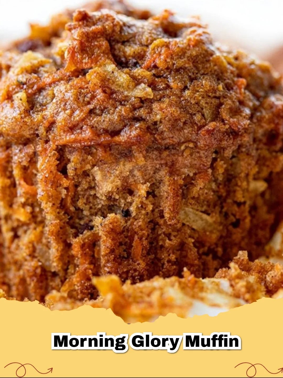 A close-up of healthy morning glory muffins on a cooling rack with fresh carrots in the background.