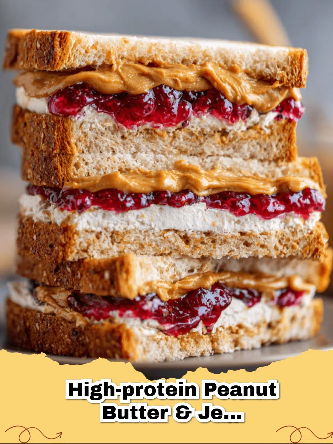 A High-Protein Peanut Butter & Jelly Sandwich sliced on a wooden board