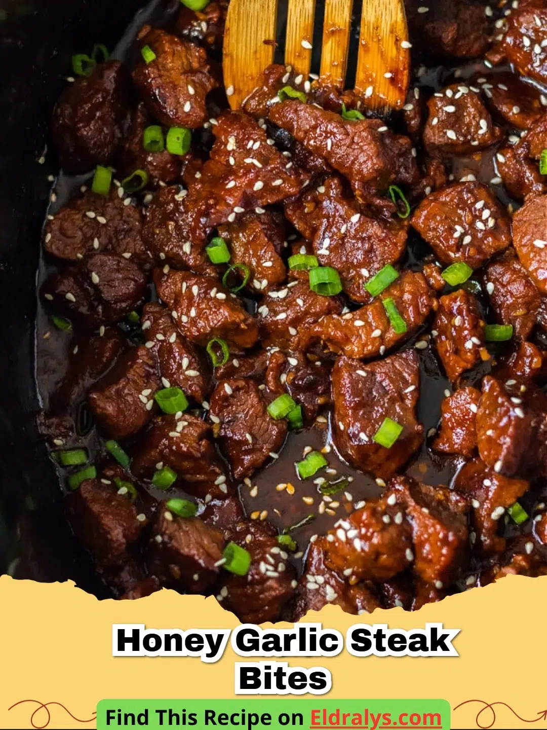 A close up shot of glistening Honey Garlic Steak Bites in a cast iron skillet garnished with green onions