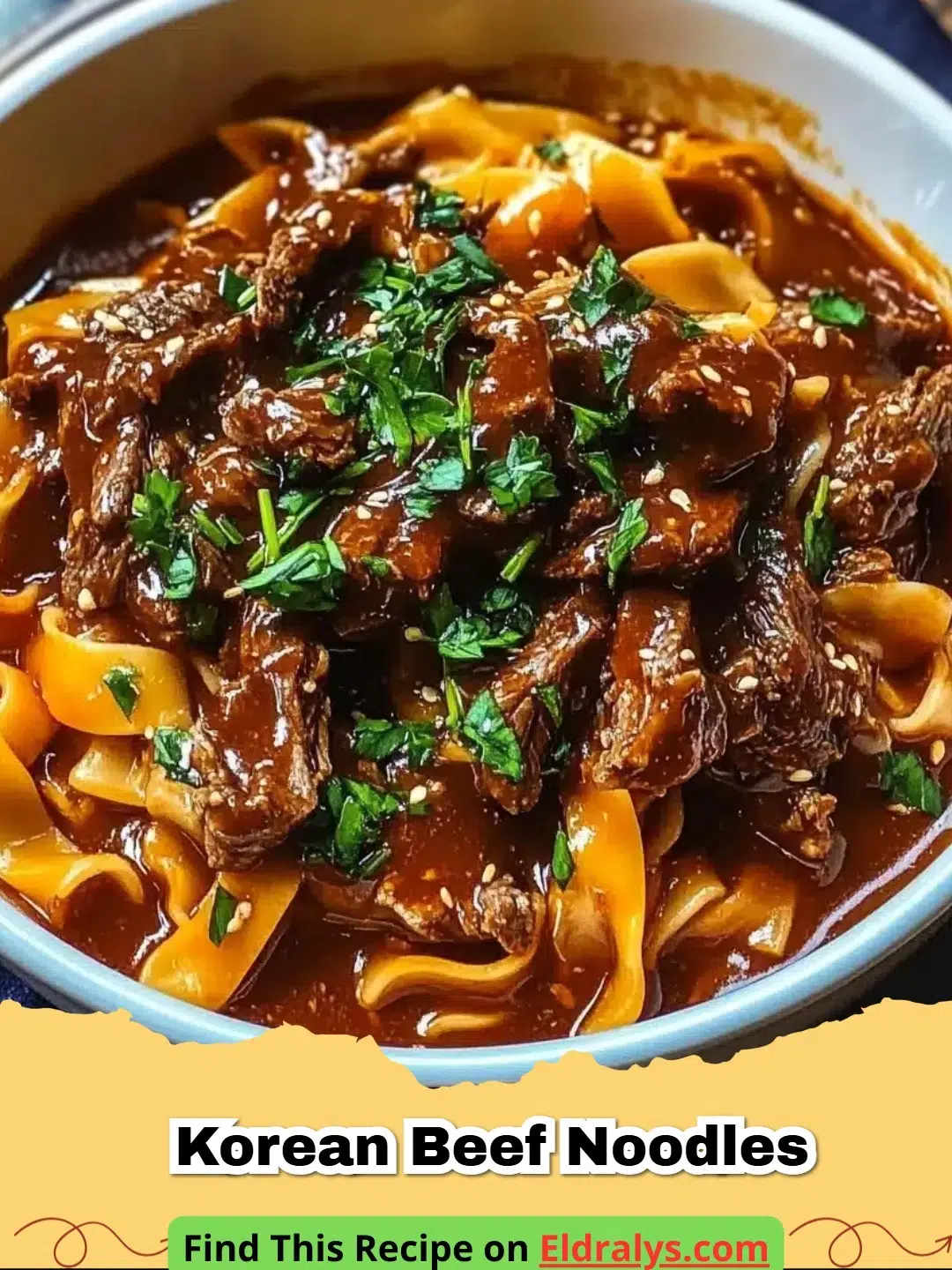 A steaming bowl of Korean Beef Noodles topped with sesame seeds and green onions.