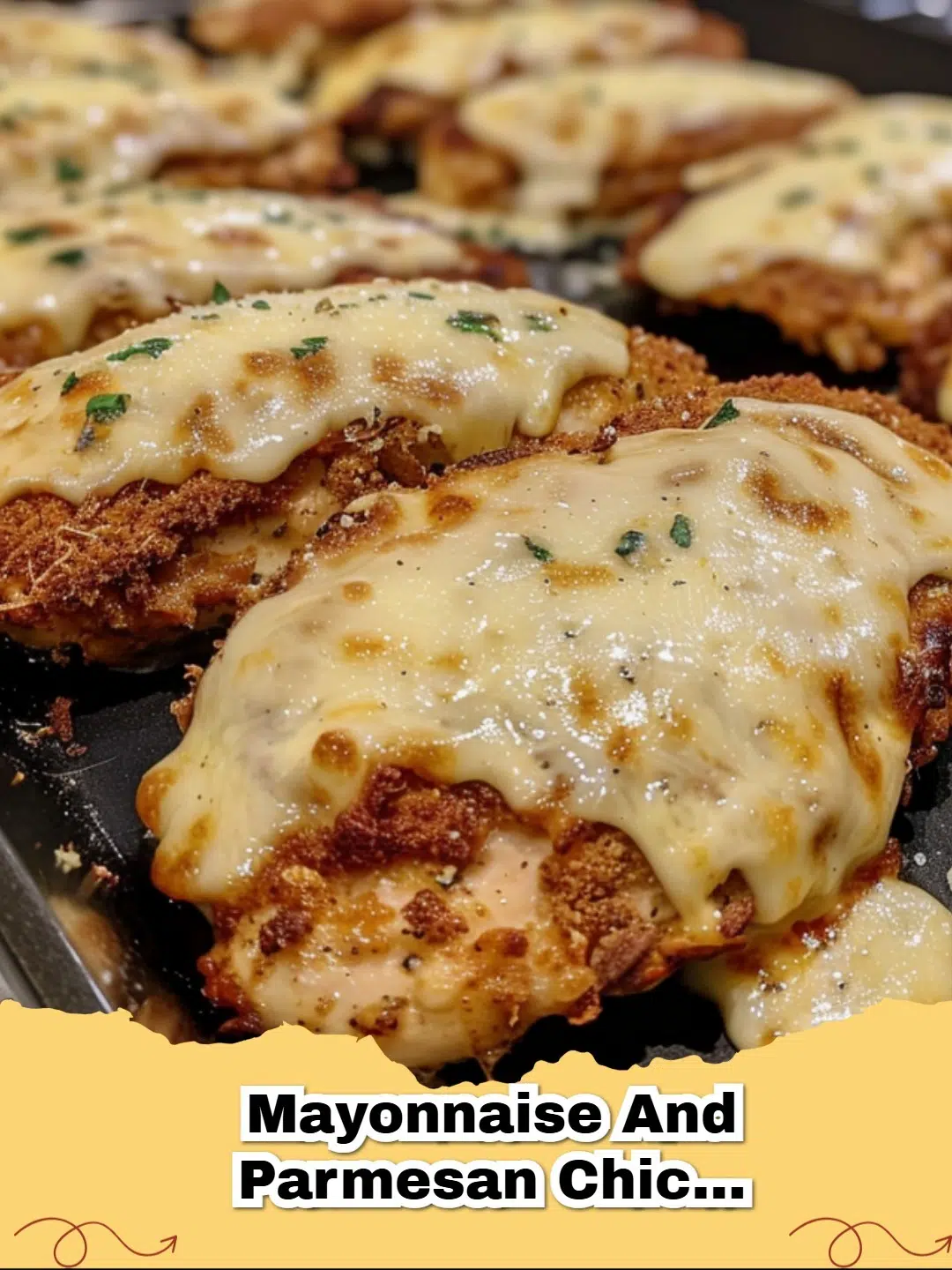 Golden brown Mayonnaise Parmesan Chicken baked in a dish, garnished with fresh parsley.