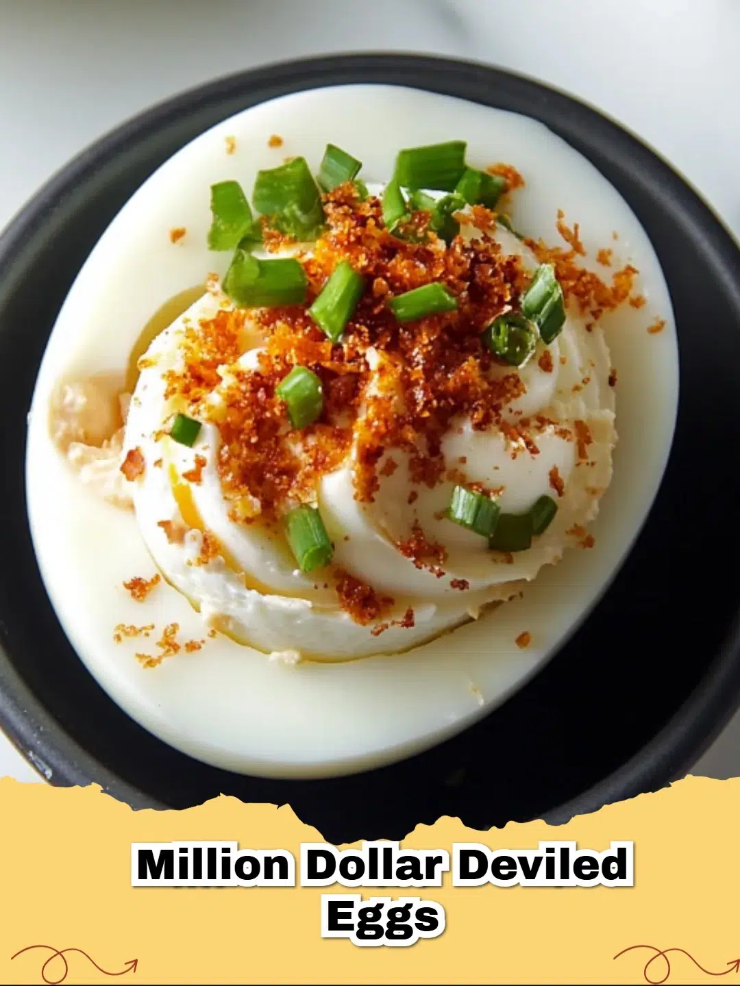 A plate of Million Dollar Deviled Eggs garnished with bacon and chives.