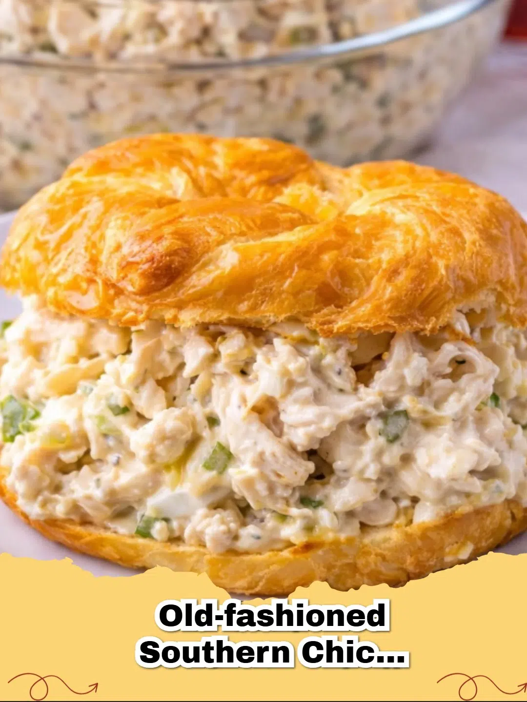 A bowl of creamy Old-Fashioned Southern Chicken Salad with celery and a sprinkle of paprika, served with crackers.