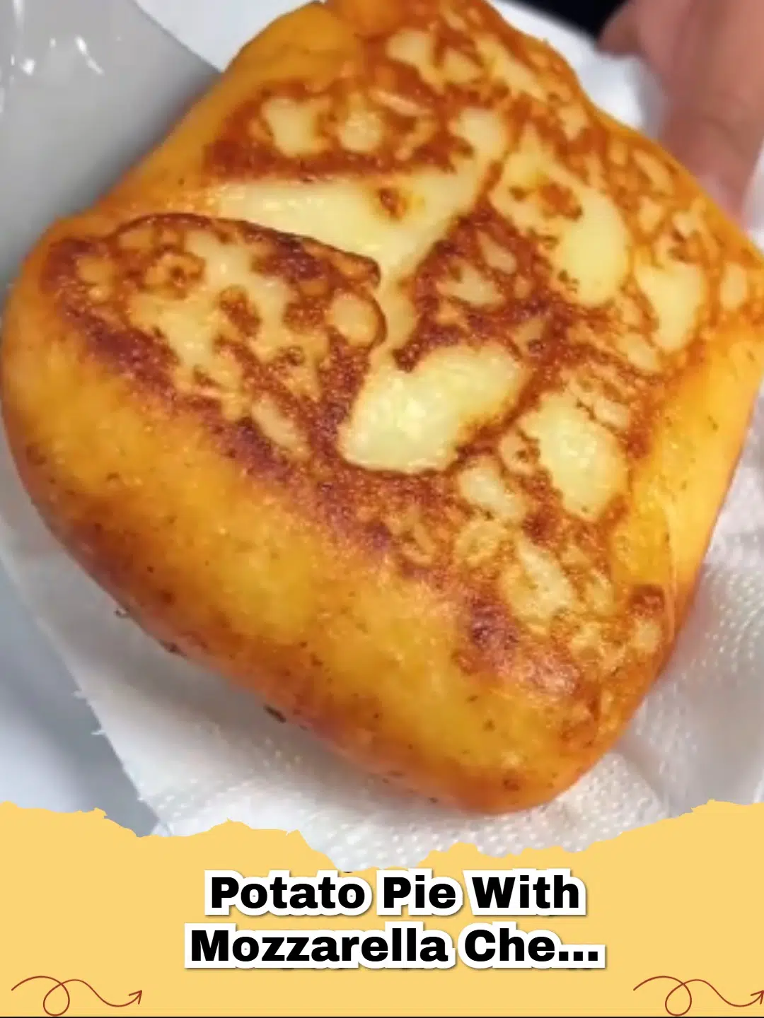 Golden brown potato pie with melted mozzarella cheese and herbs