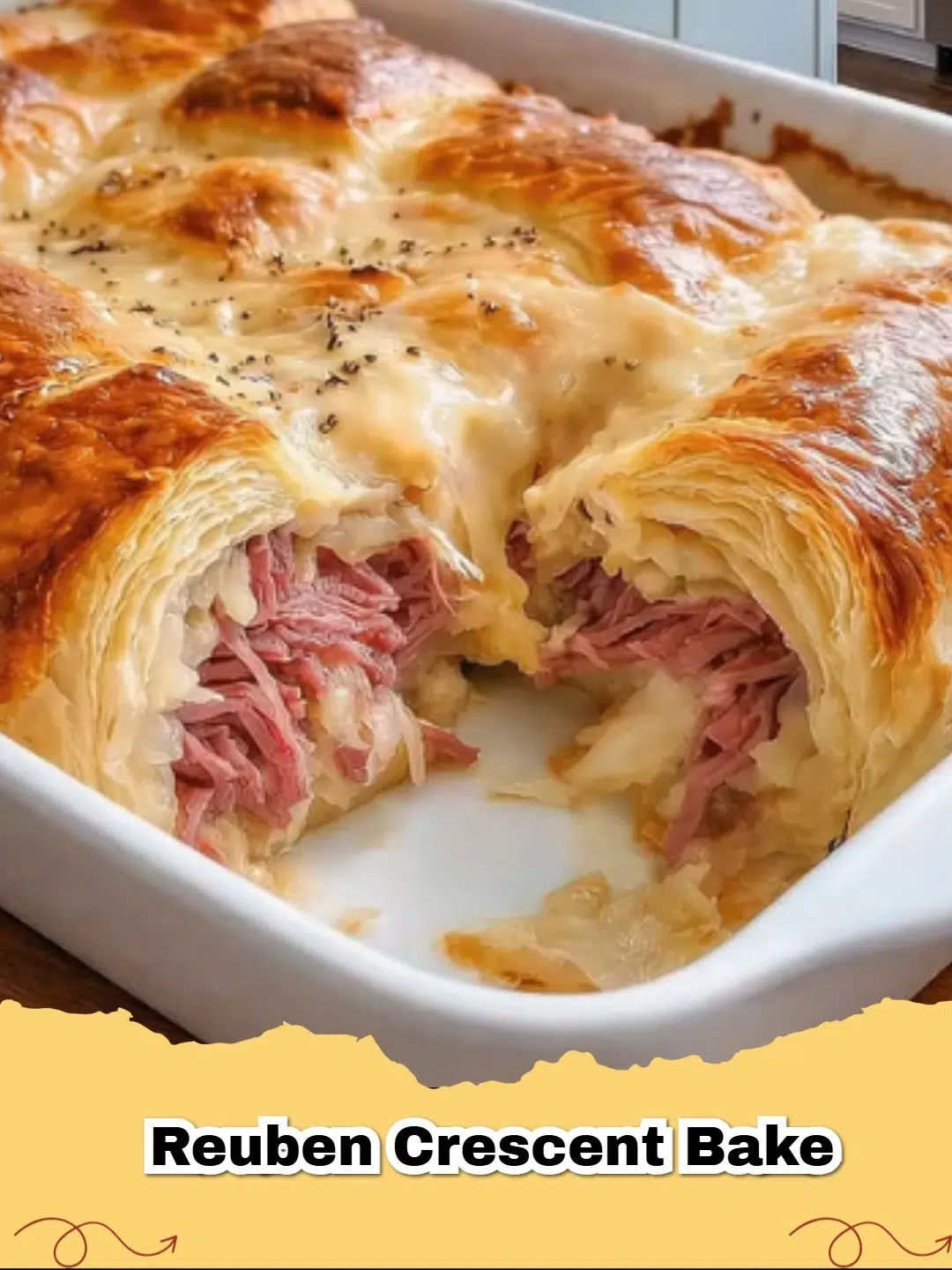 Golden brown Reuben Crescent Bake sliced and served in a baking dish.