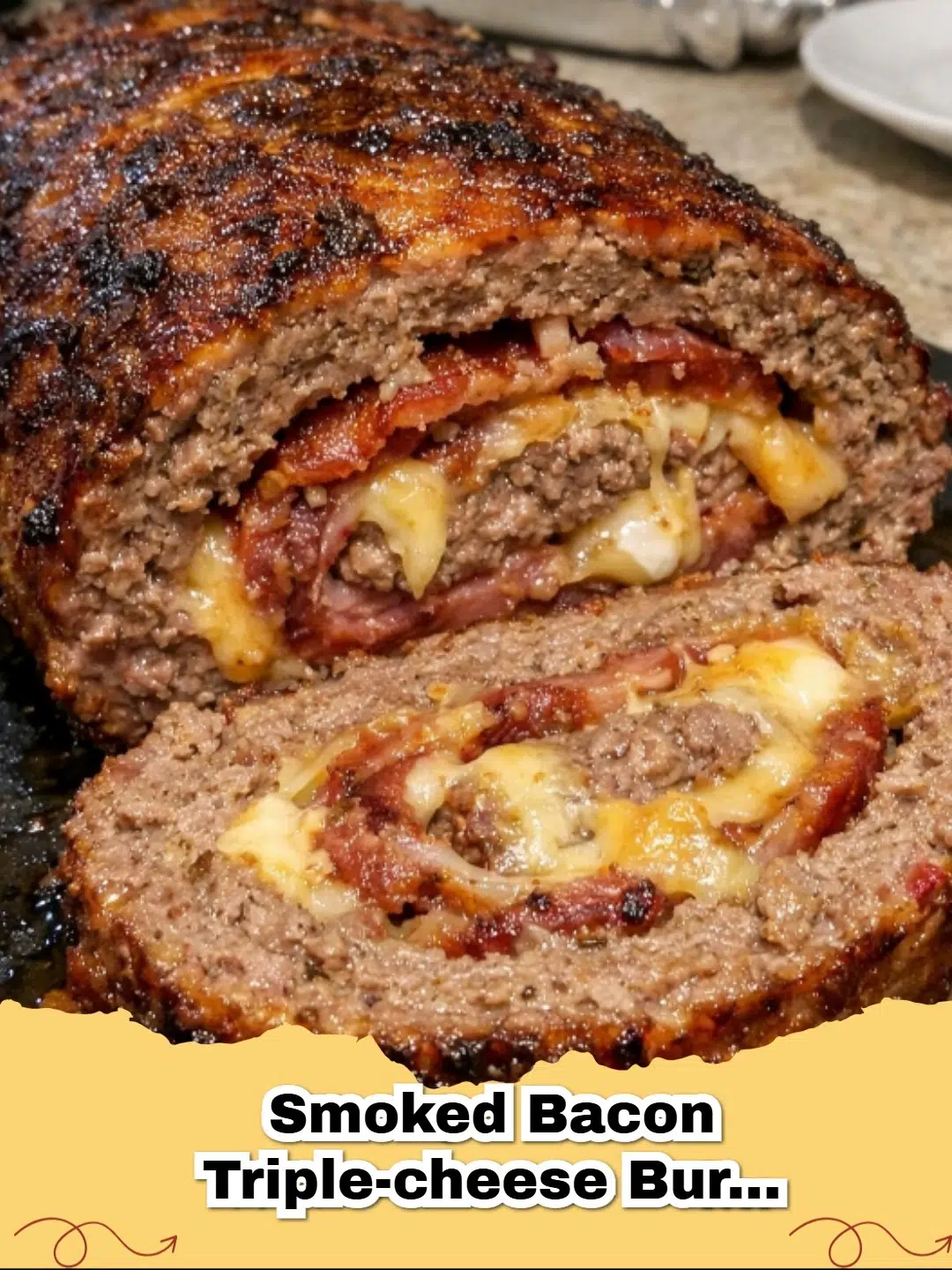 Delicious Smoked Bacon Cheeseburger Stuffed Meatloaf sliced, revealing melted cheese inside.