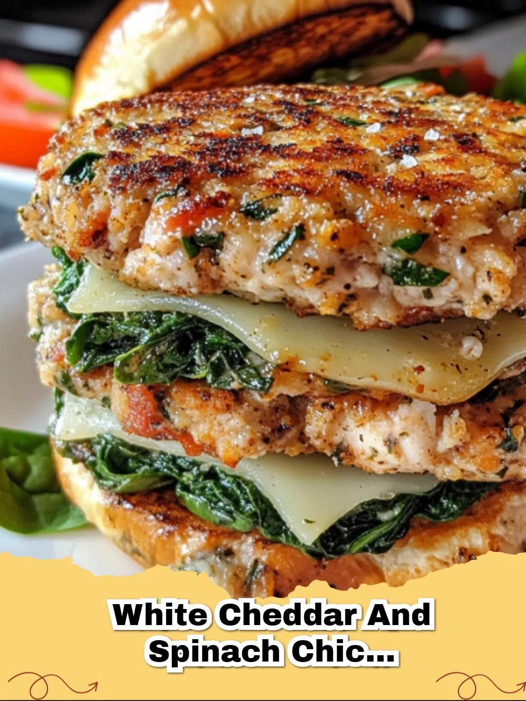 A juicy Spinach and White Cheddar Chicken Burger on a toasted brioche bun with lettuce and tomato.