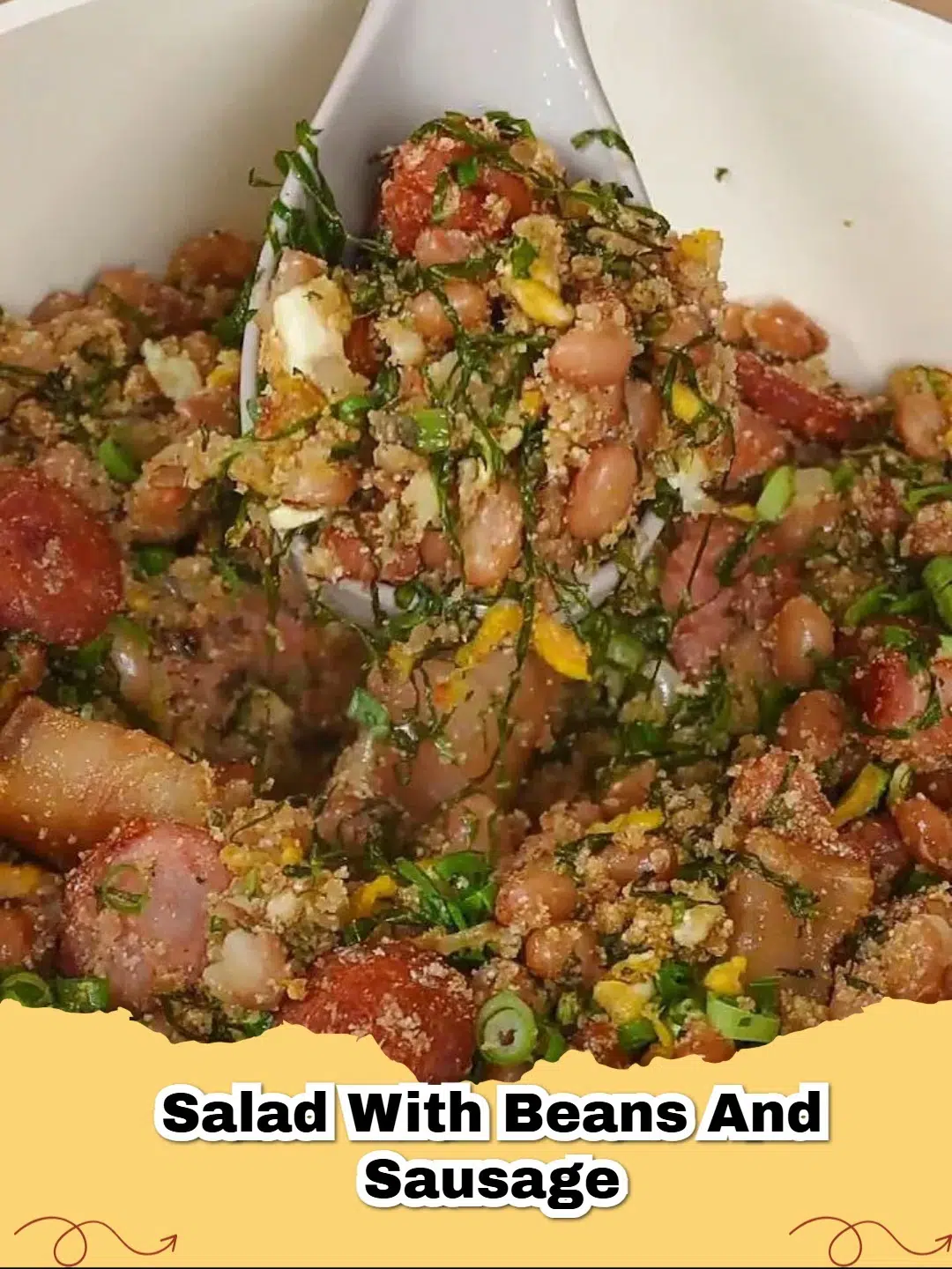 A close-up shot of a White Bean and Smoked Sausage Salad with fresh herbs and pistachios.