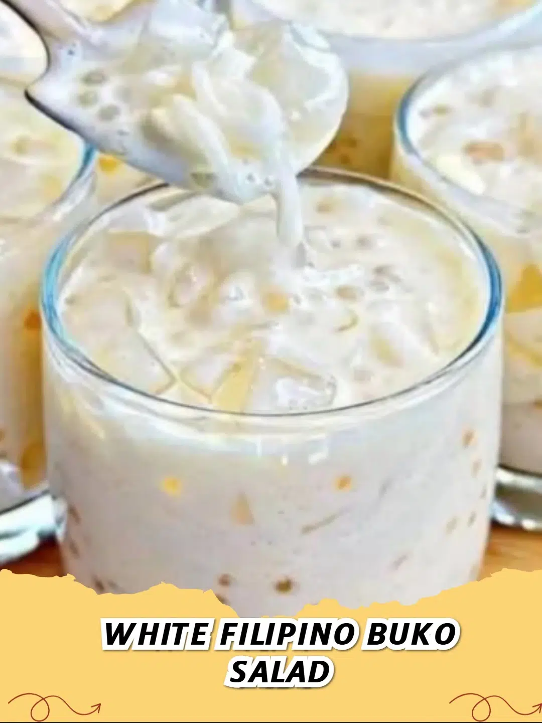 Creamy White Filipino Buko Salad with young coconut strips, agar-agar jelly, and tapioca pearls in a clear serving bowl.