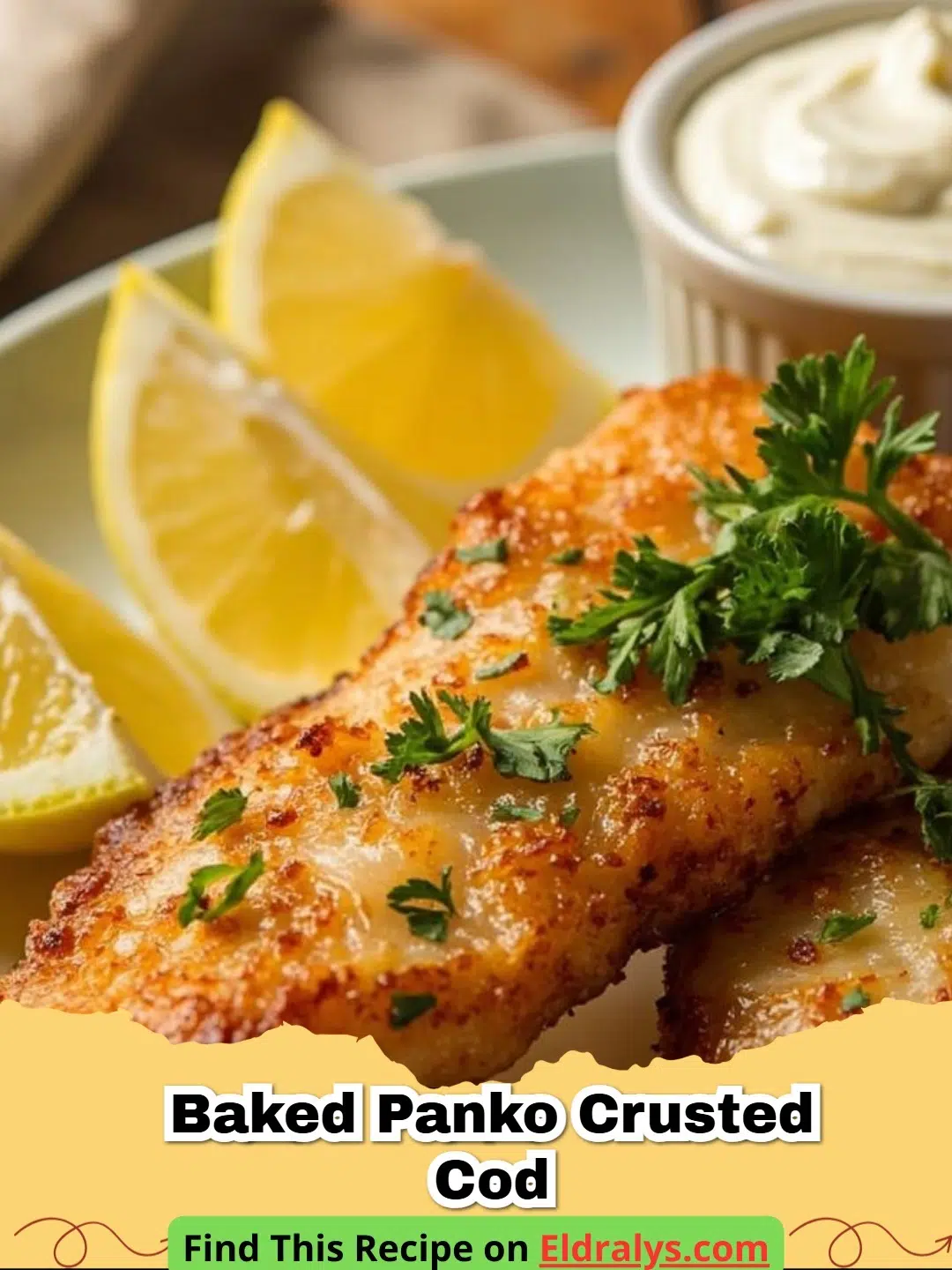 A golden-brown Baked Panko Crusted Cod fillet served with a lemon wedge and fresh parsley.