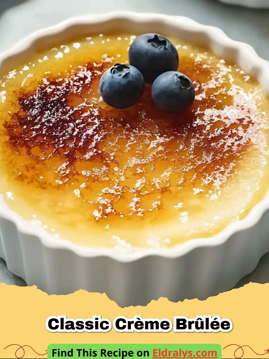 A close up of a Classic Crème Brûlée Recipe showing a spoon breaking the caramelized sugar crust.