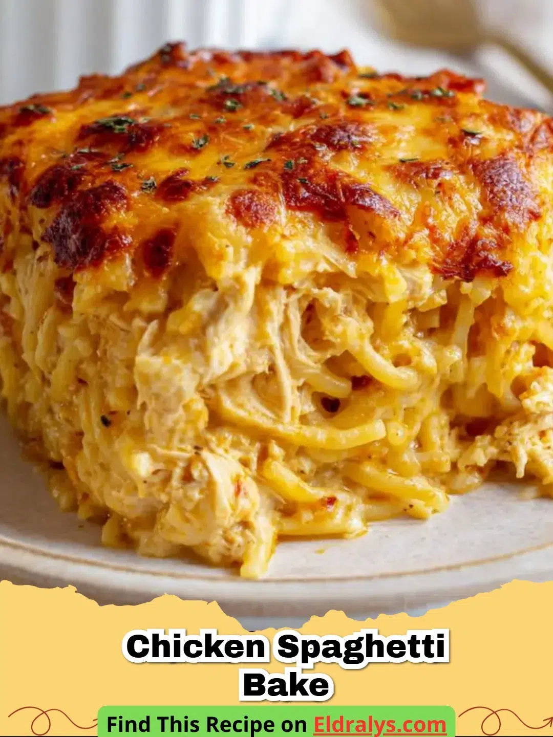 A close-up shot of a cheesy and Creamy Chicken Spaghetti Bake in a ceramic dish.