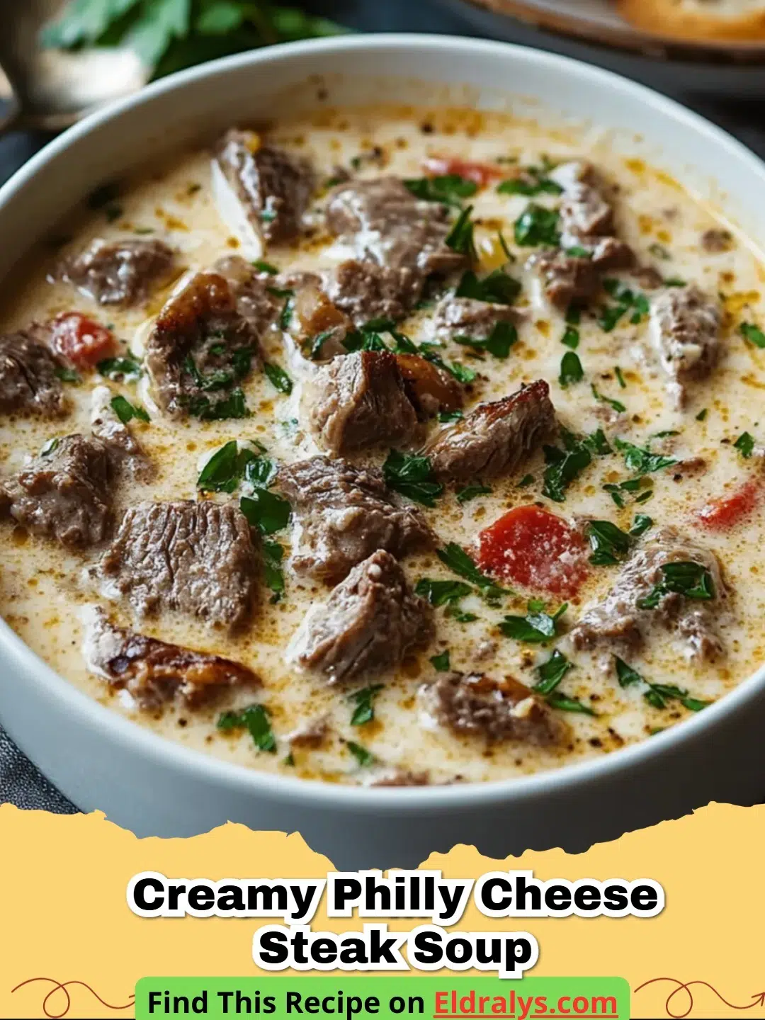 A bowl of Creamy Philly Cheese Steak Soup topped with fresh parsley and served with crusty bread.