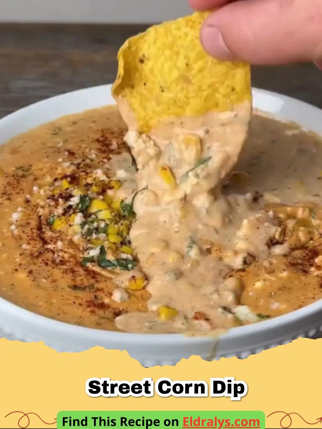 A bowl of creamy Street Corn Dip topped with cotija cheese and cilantro.