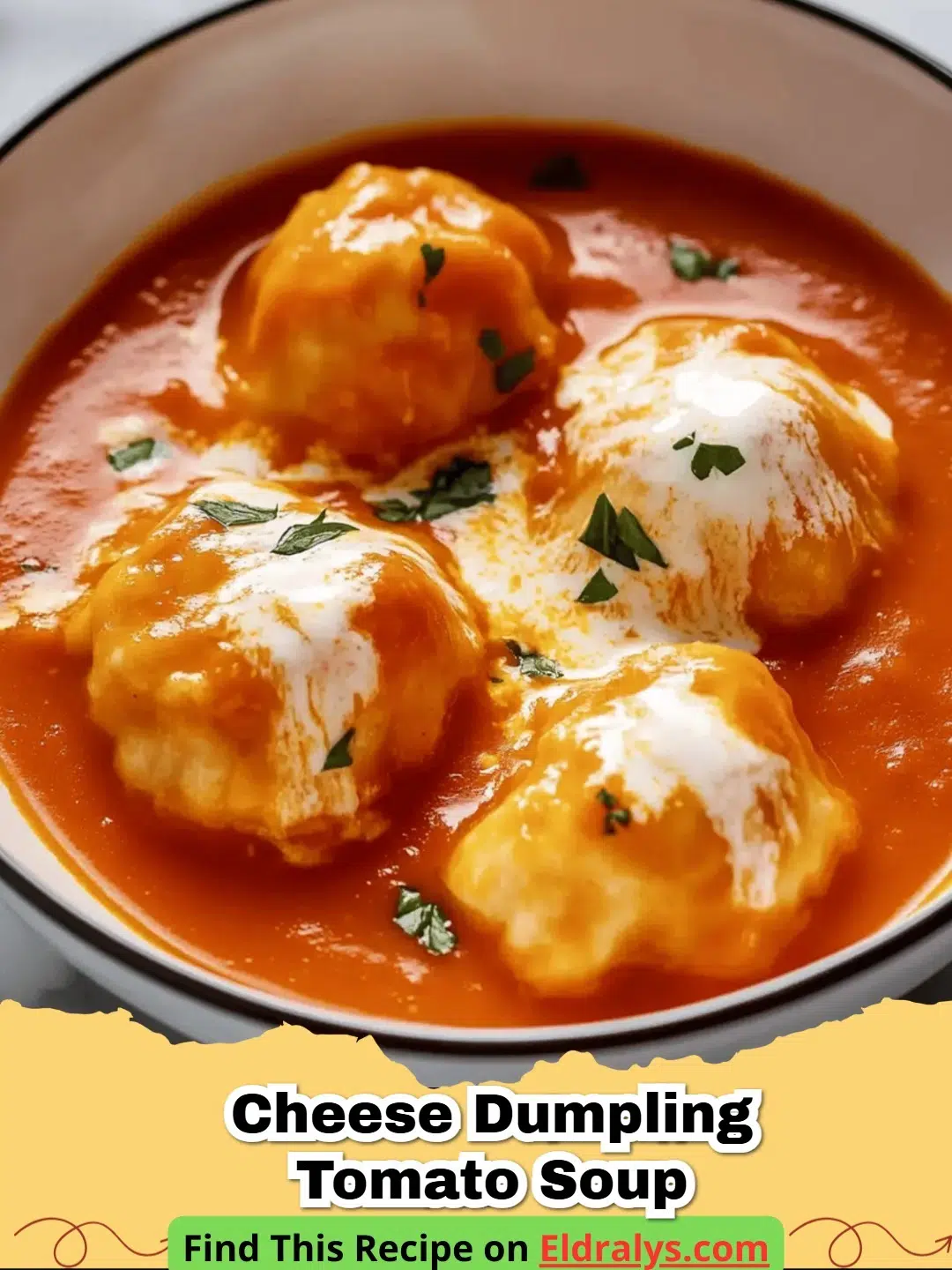 A bowl of Creamy Tomato Soup with Cheese Dumplings garnished with fresh herbs.