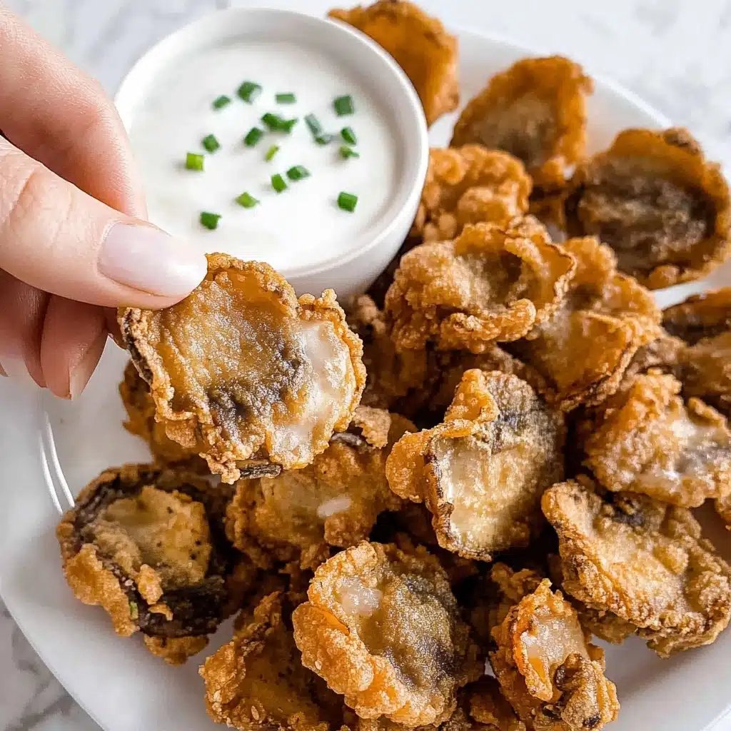 Golden brown crispy fried mushrooms on a serving platter with dipping sauce