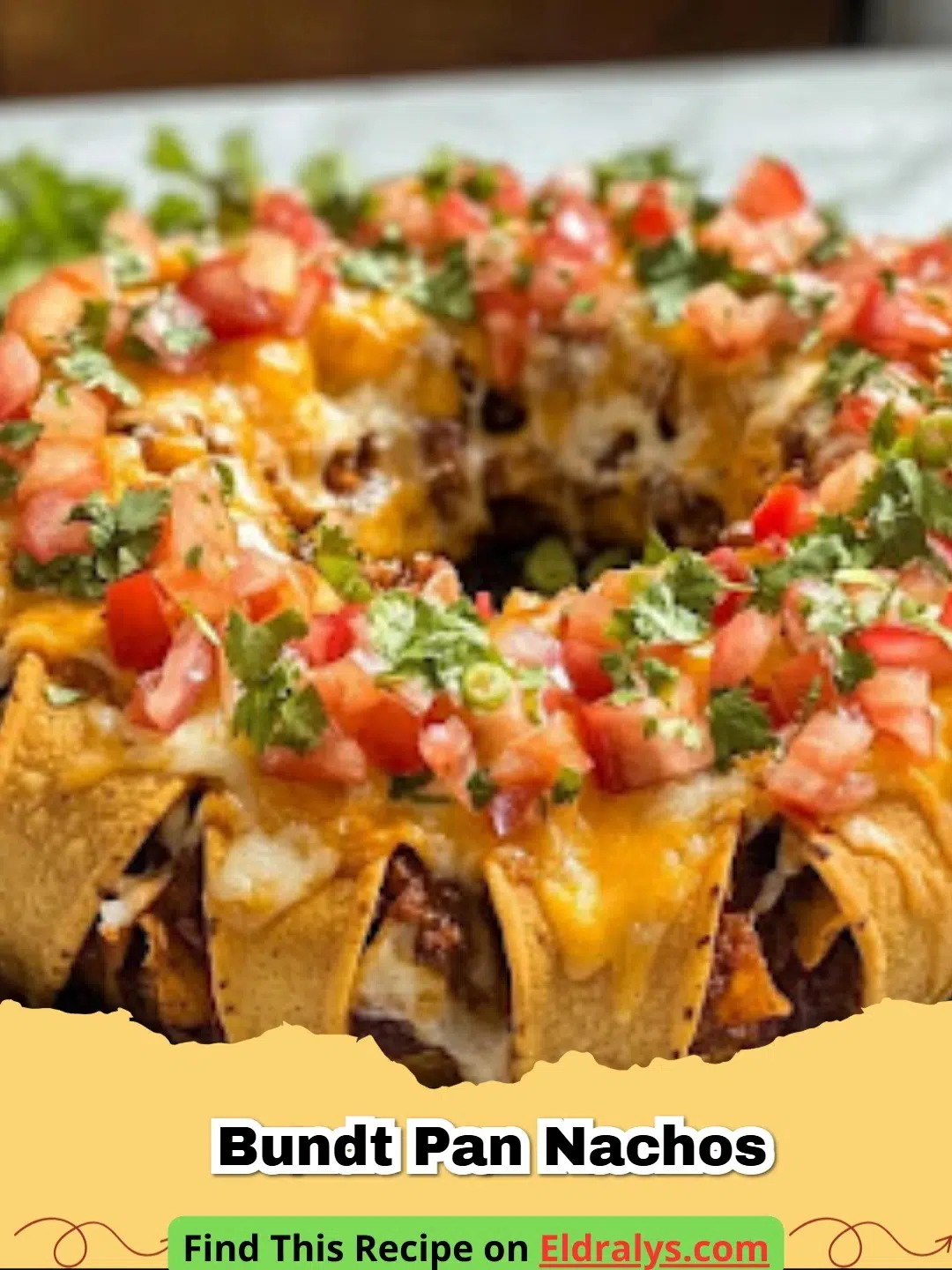 A towering ring of Easy Bundt Pan Nachos loaded with melted cheese, beef, and jalapeƱos on a white serving platter.