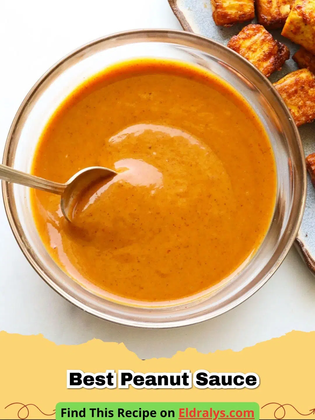 A close up bowl of Easy Thai Peanut Sauce Recipe with a whisk