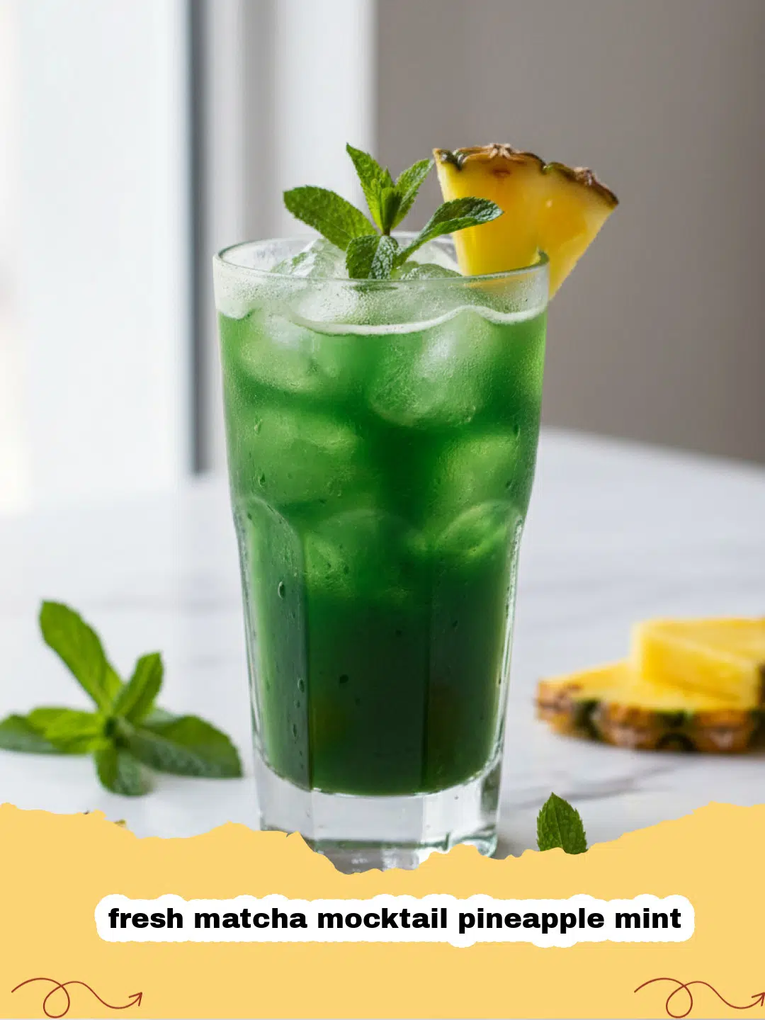 A vibrant green fresh matcha mocktail pineapple mint in a tall glass with pineapple and mint garnish.