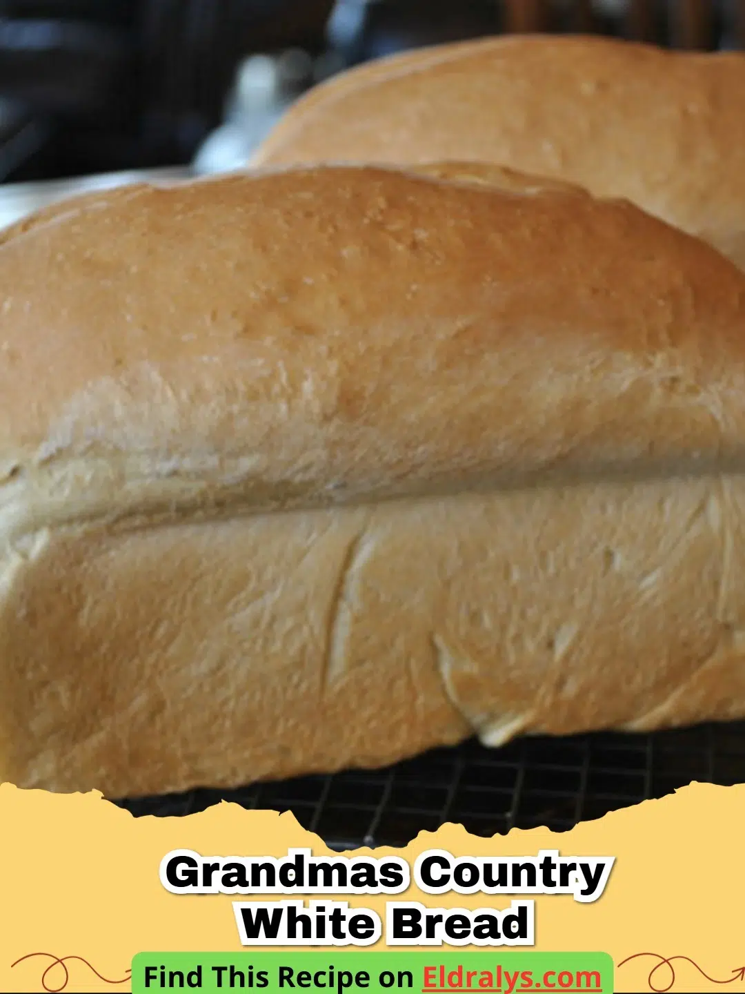 Two golden loaves of grandmas country white bread sitting on a rustic wooden table.