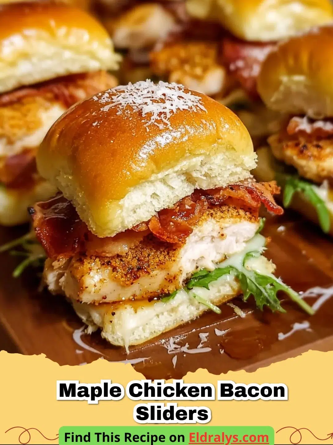 A close up shot of Maple Chicken Bacon Sliders on a wooden board with melted cheese.