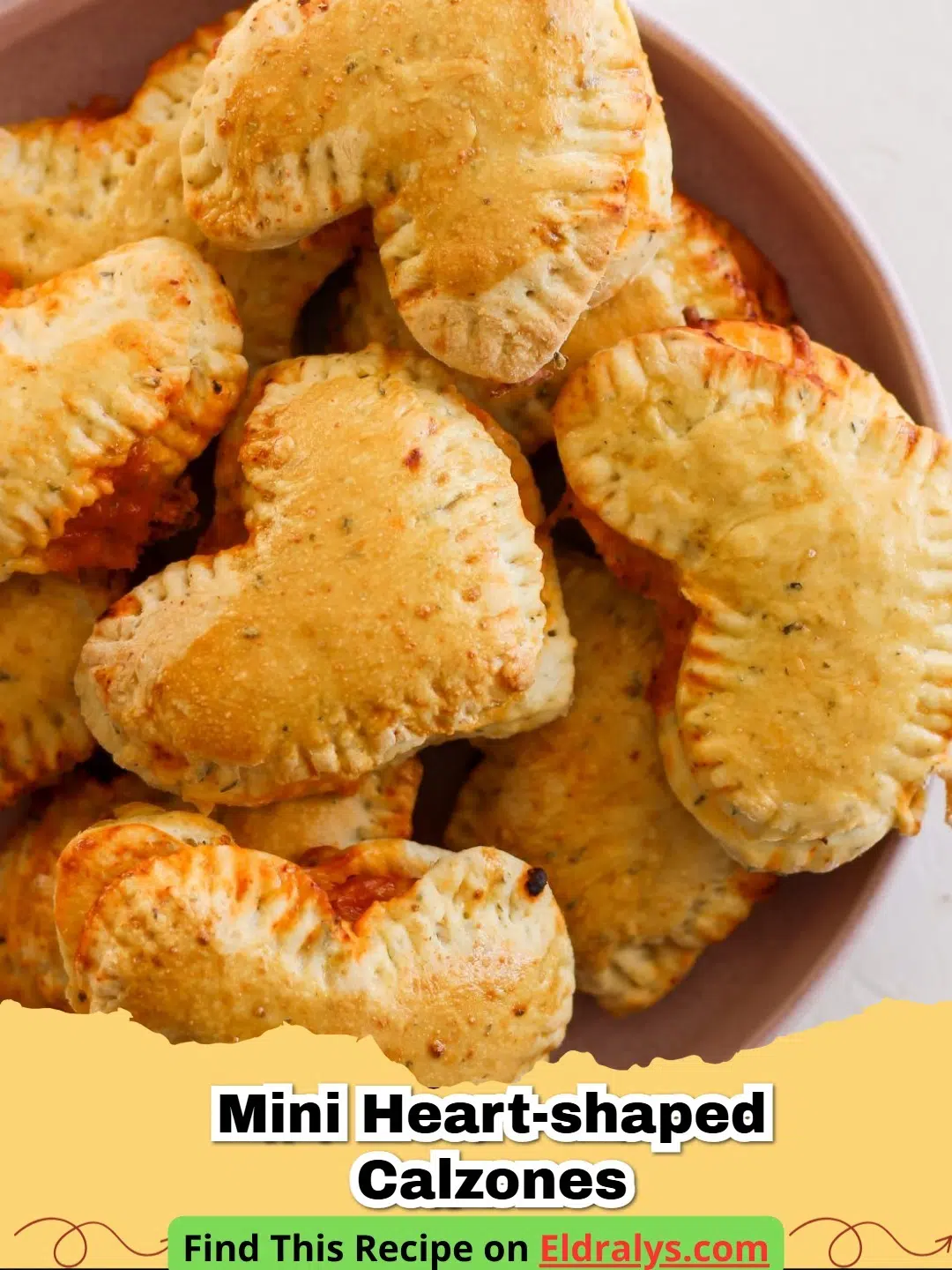 Golden brown Mini Heart-Shaped Calzones on a baking sheet