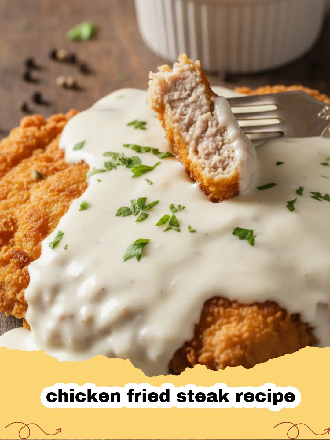 chicken fried steak recipe - A golden brown chicken fried steak covered in white pepper gravy on a white plate with mashed potatoes.