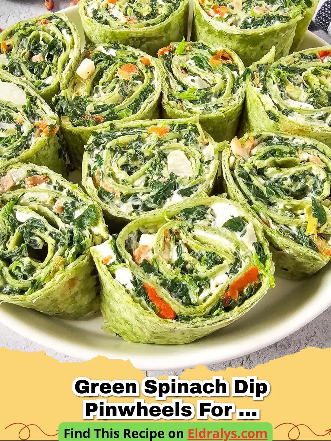 Close up of green Spinach Dip Pinwheels with Bacon arranged on a white serving platter.