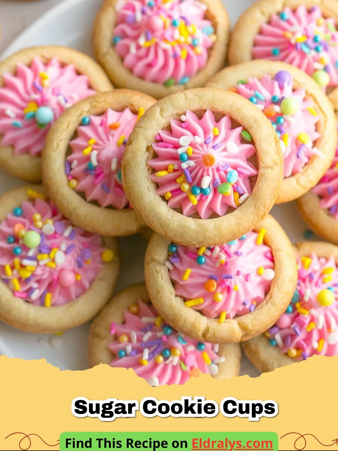 A close up of Sugar Cookie Cups with Cream Cheese Frosting topped with pink frosting and sprinkles.