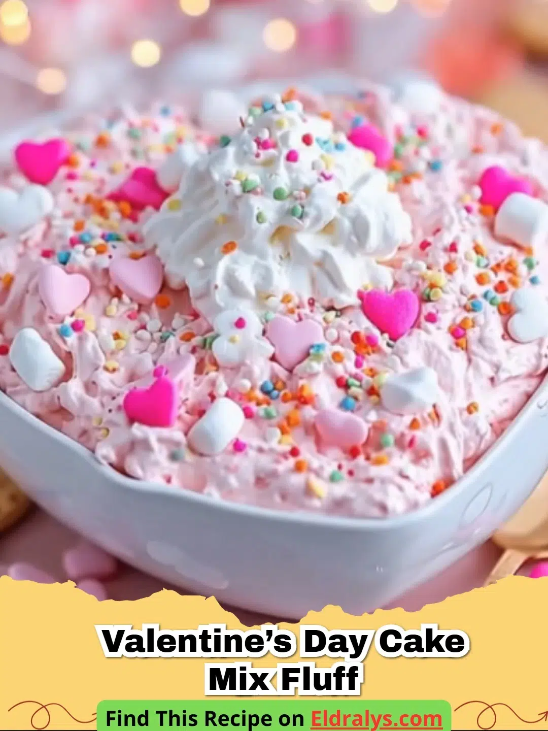A close up bowl of pink Valentine’s Day Cake Mix Fluff topped with heart sprinkles