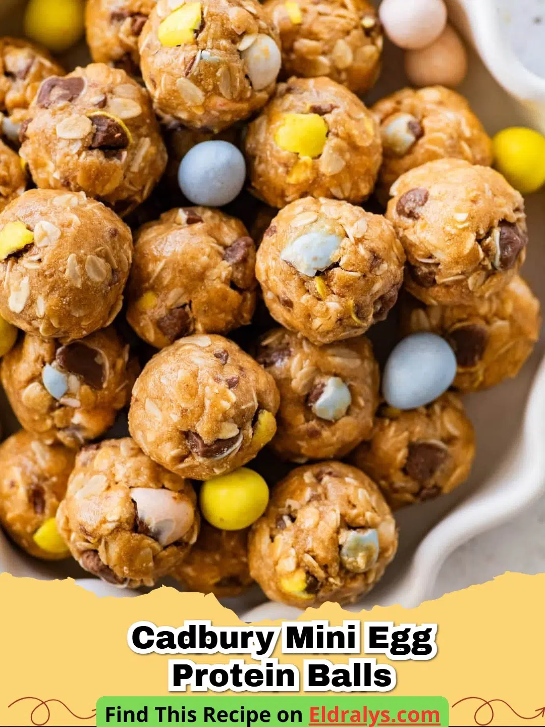 A close up shot of several Cadbury Egg Protein Balls on a white plate with whole mini eggs around them.