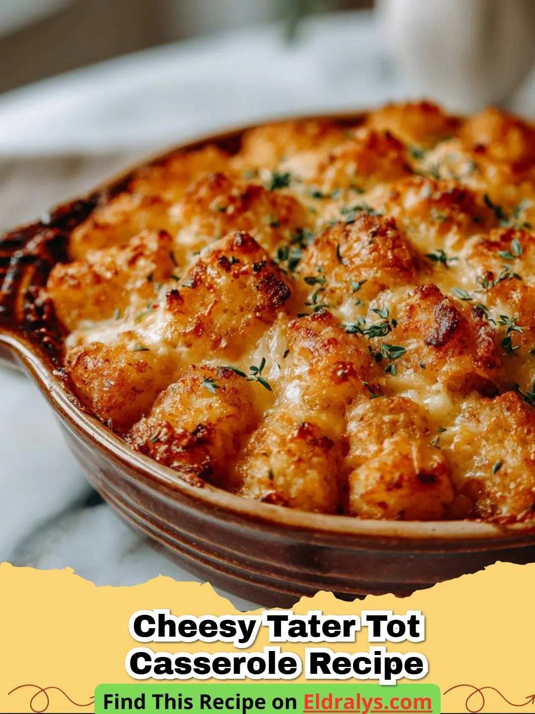 A hot and bubbly Cheesy Tater Tot Casserole in a glass baking dish topped with green onions.