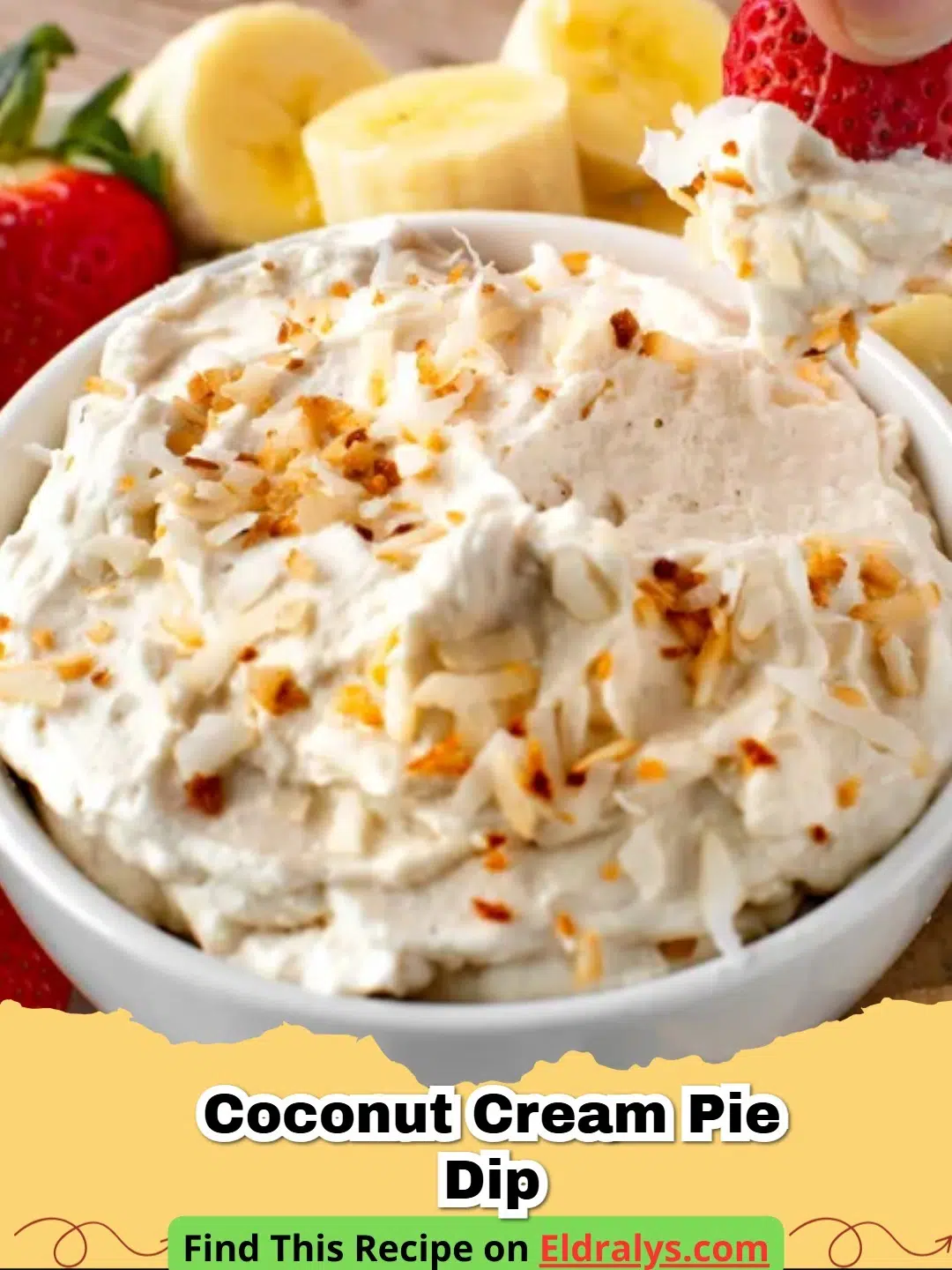A bowl of creamy Coconut Cream Pie Dip topped with toasted coconut shreds next to graham crackers.