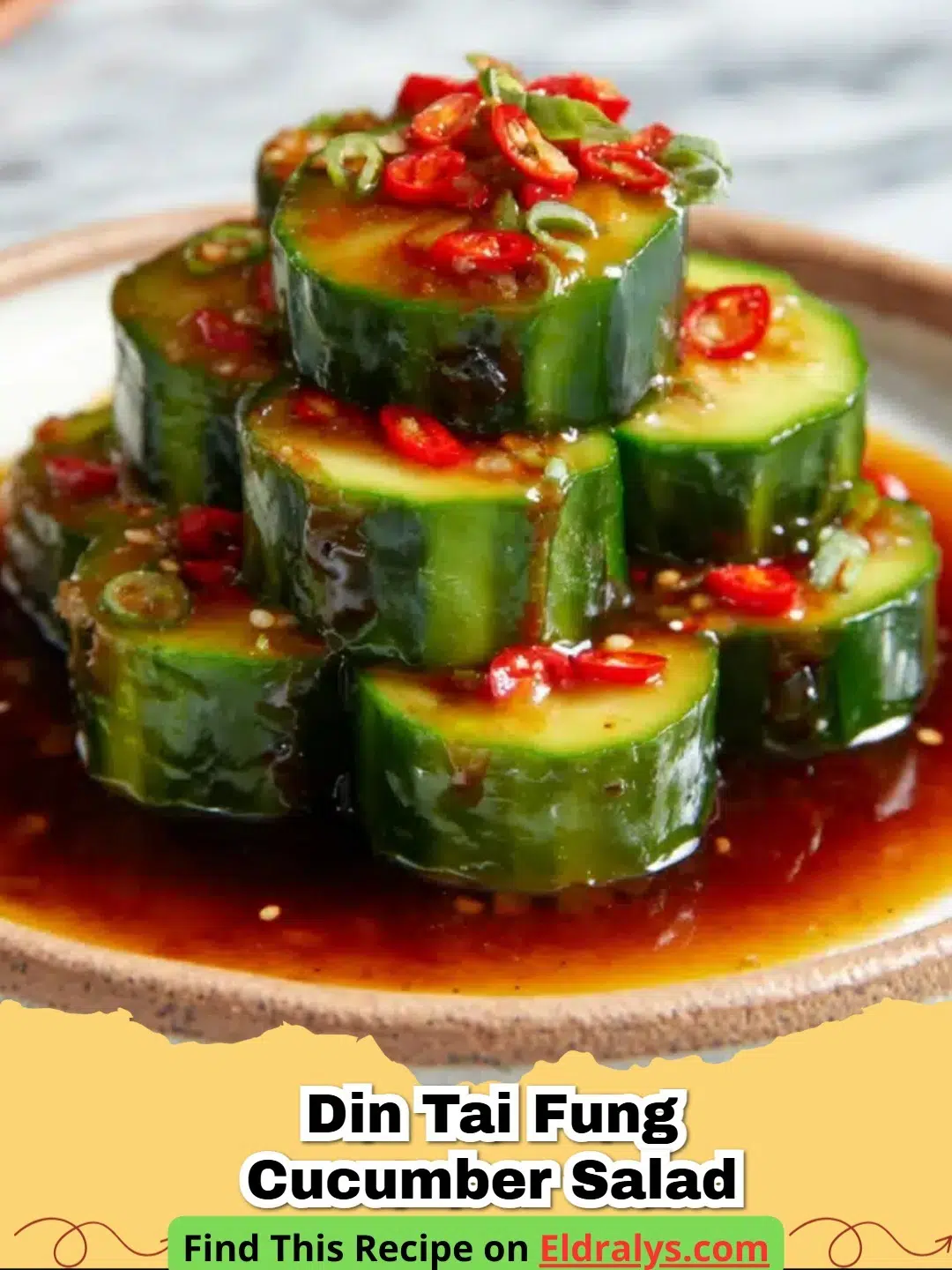 A stacked spiral of Din Tai Fung Cucumber Salad (Copycat Recipe) on a white plate with chili oil.