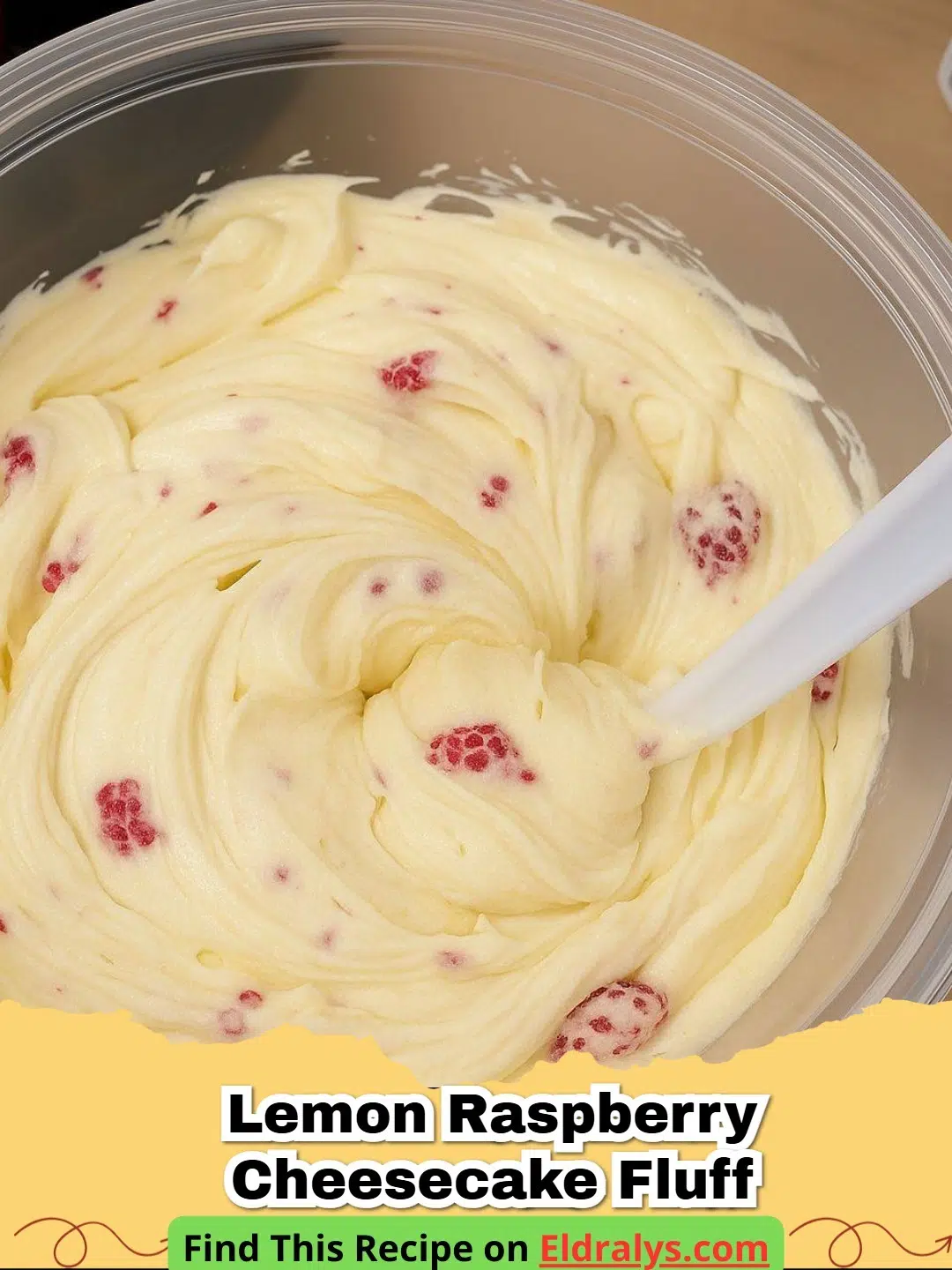 A bowl of Easy Sugar-Free Lemon Raspberry Cheesecake Fluff topped with fresh raspberries and lemon zest.