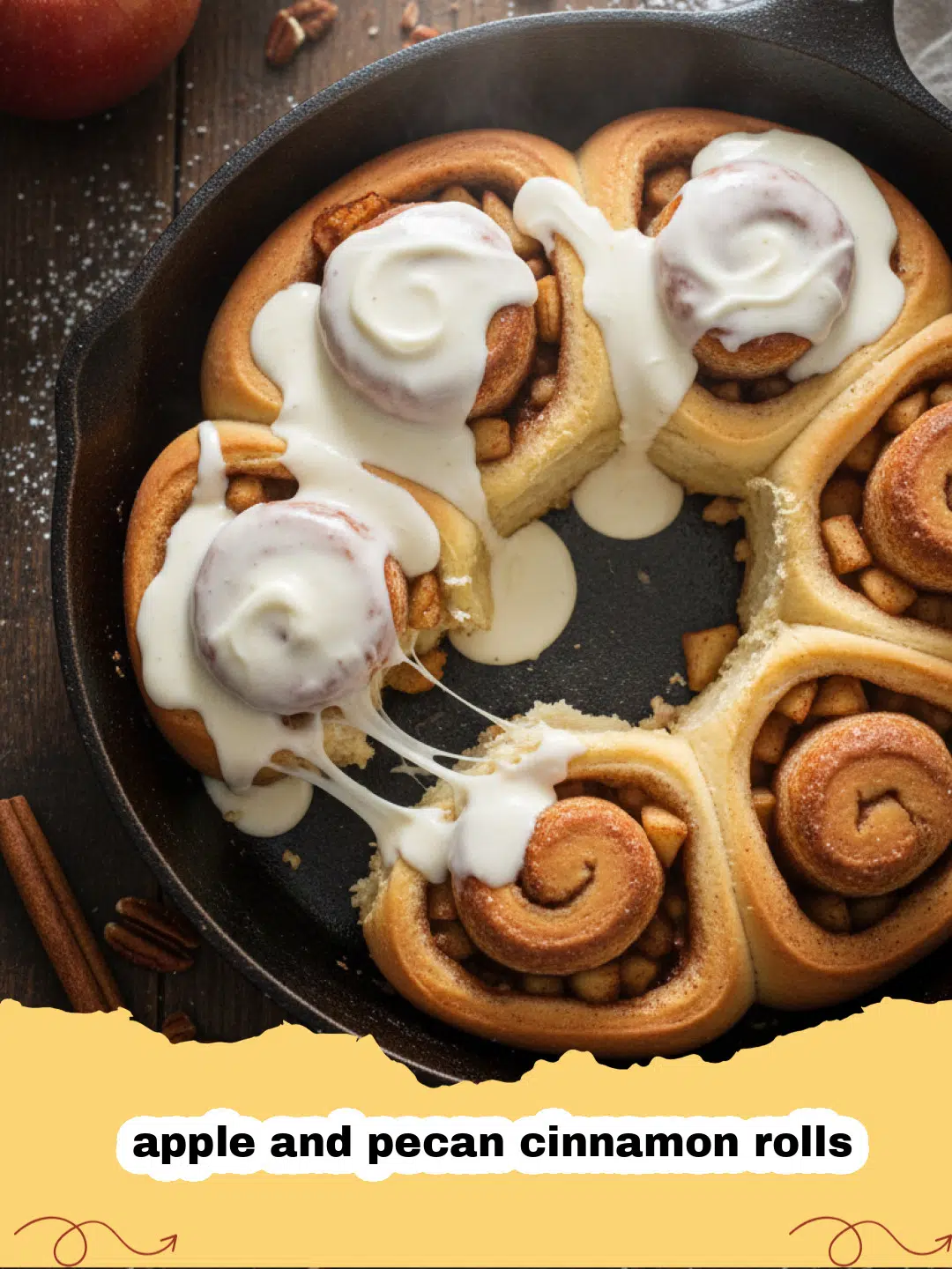 A tray of golden brown apple and pecan cinnamon rolls with drizzled icing