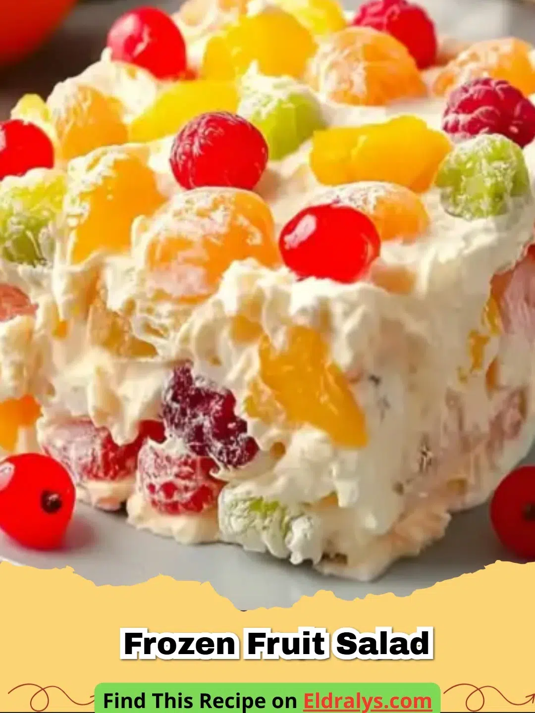 A close-up shot of a sliced square of creamy Frozen Fruit Salad with colorful fruit pieces visible.
