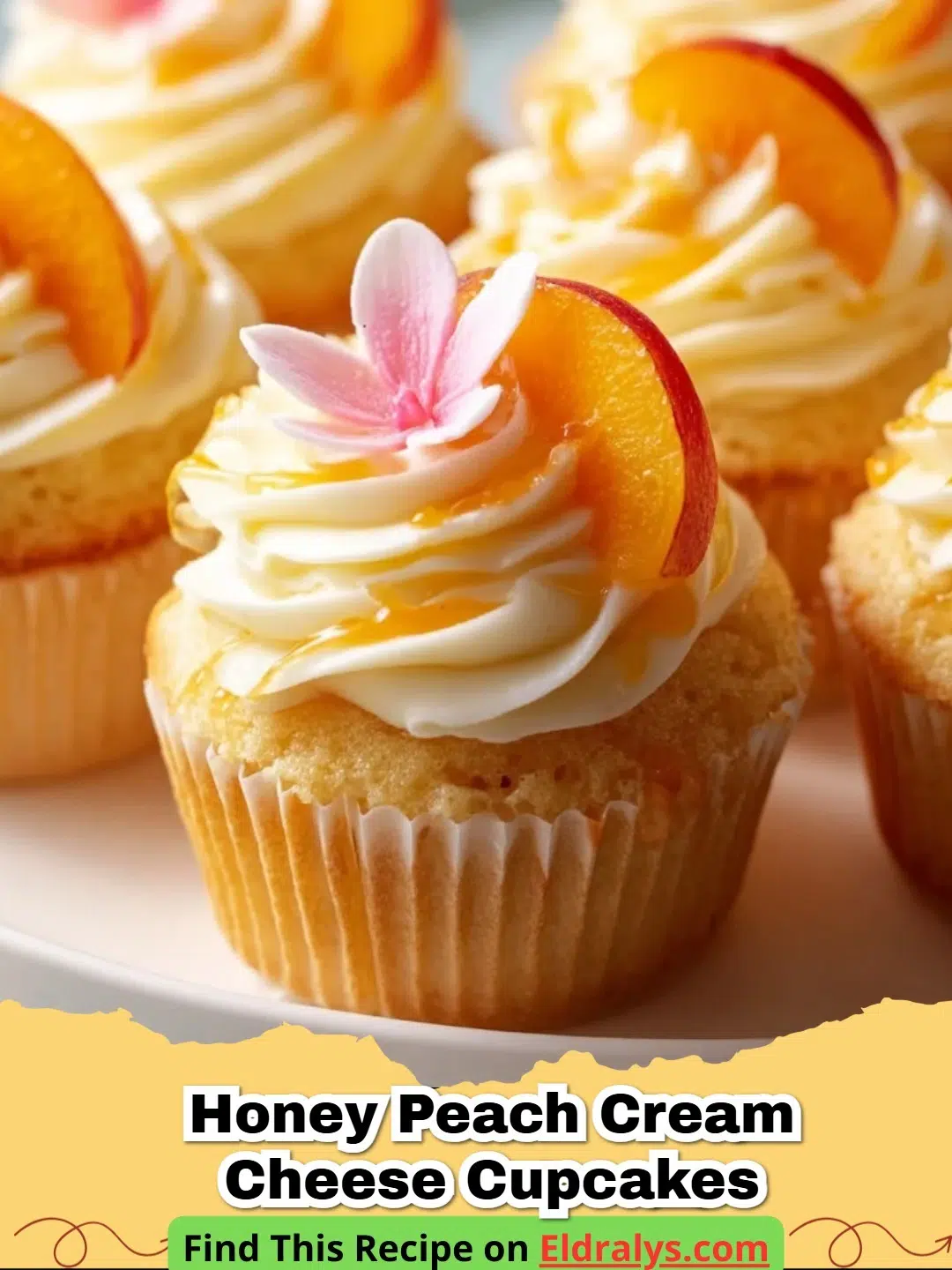 A close-up shot of Honey Peach Cream Cheese Cupcakes with golden honey drizzle and fresh peach slices on top.