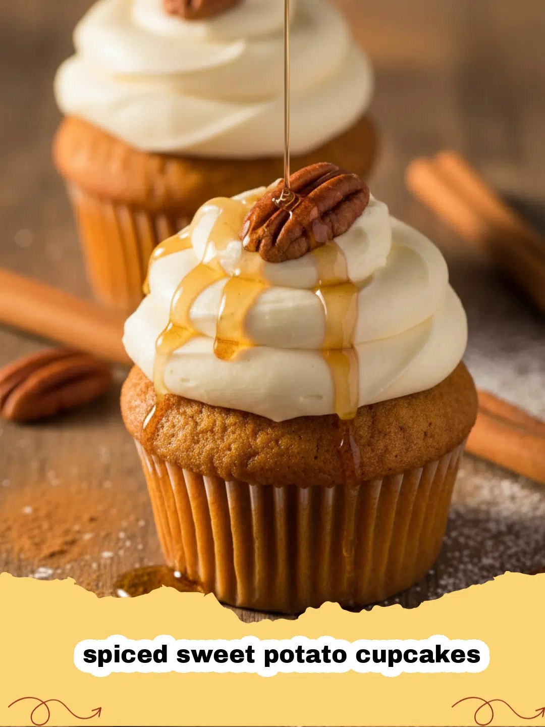 A close-up shot of several spiced sweet potato cupcakes topped with swirls of white cream cheese frosting and a sprinkle of cinnamon.
