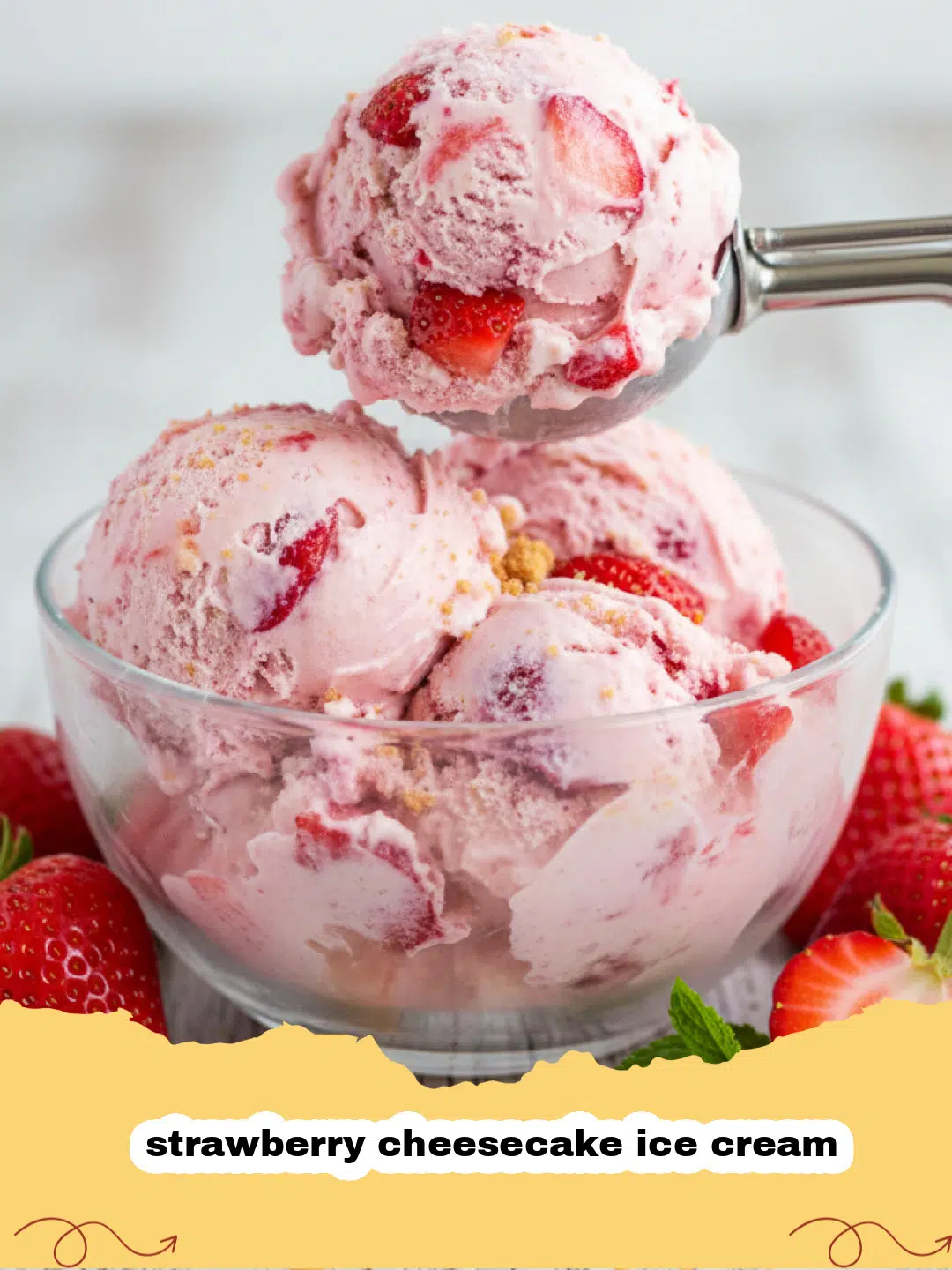 A scoop of creamy strawberry cheesecake ice cream with red strawberry swirls and graham cracker bits.