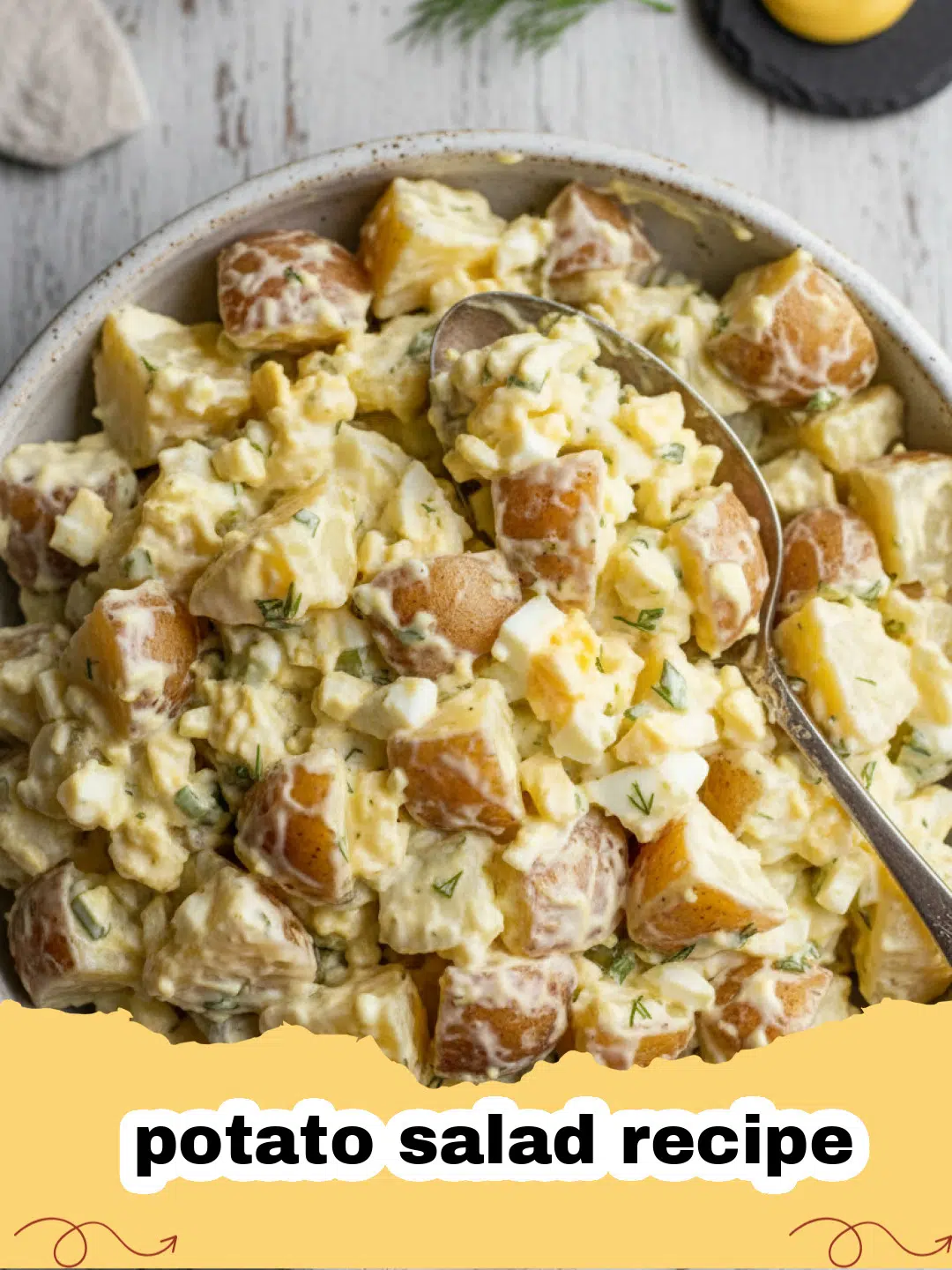 potato salad recipe - A large bowl of creamy potato salad topped with hard-boiled eggs and fresh parsley.