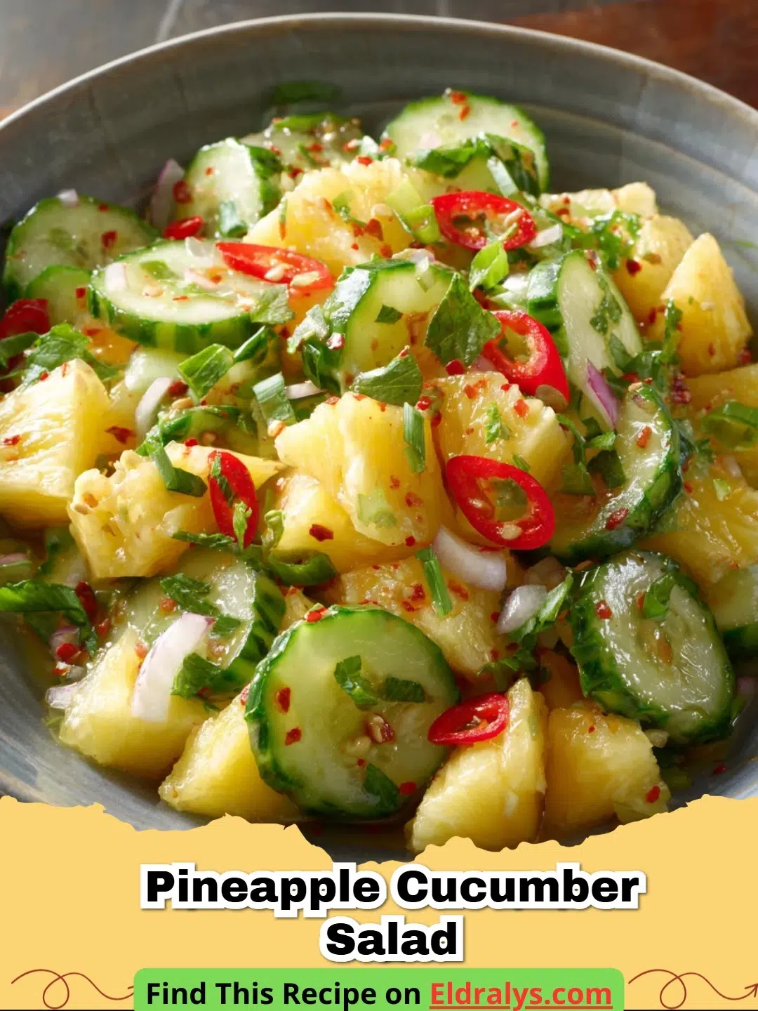 A close up of Pineapple Cucumber Salad in a white bowl with lime wedges and cilantro garnish