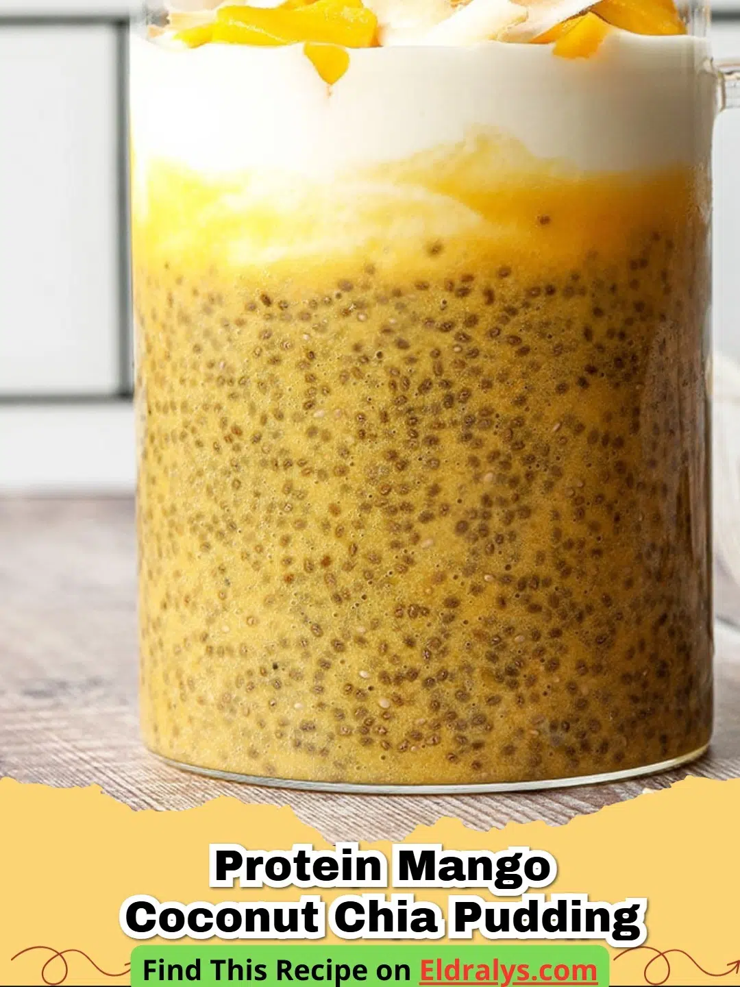 A close up photo of Protein Mango Coconut Chia Pudding layered in a glass jar with fresh mango on top.