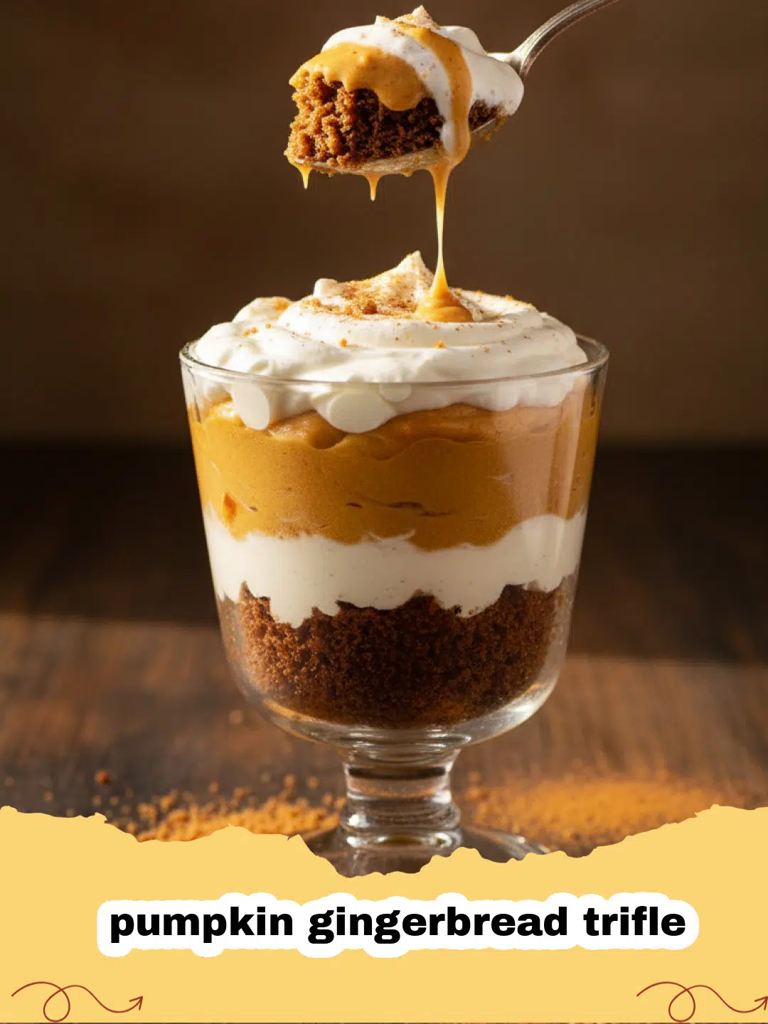 A beautiful layered pumpkin gingerbread trifle in a glass bowl with whipped cream on top.