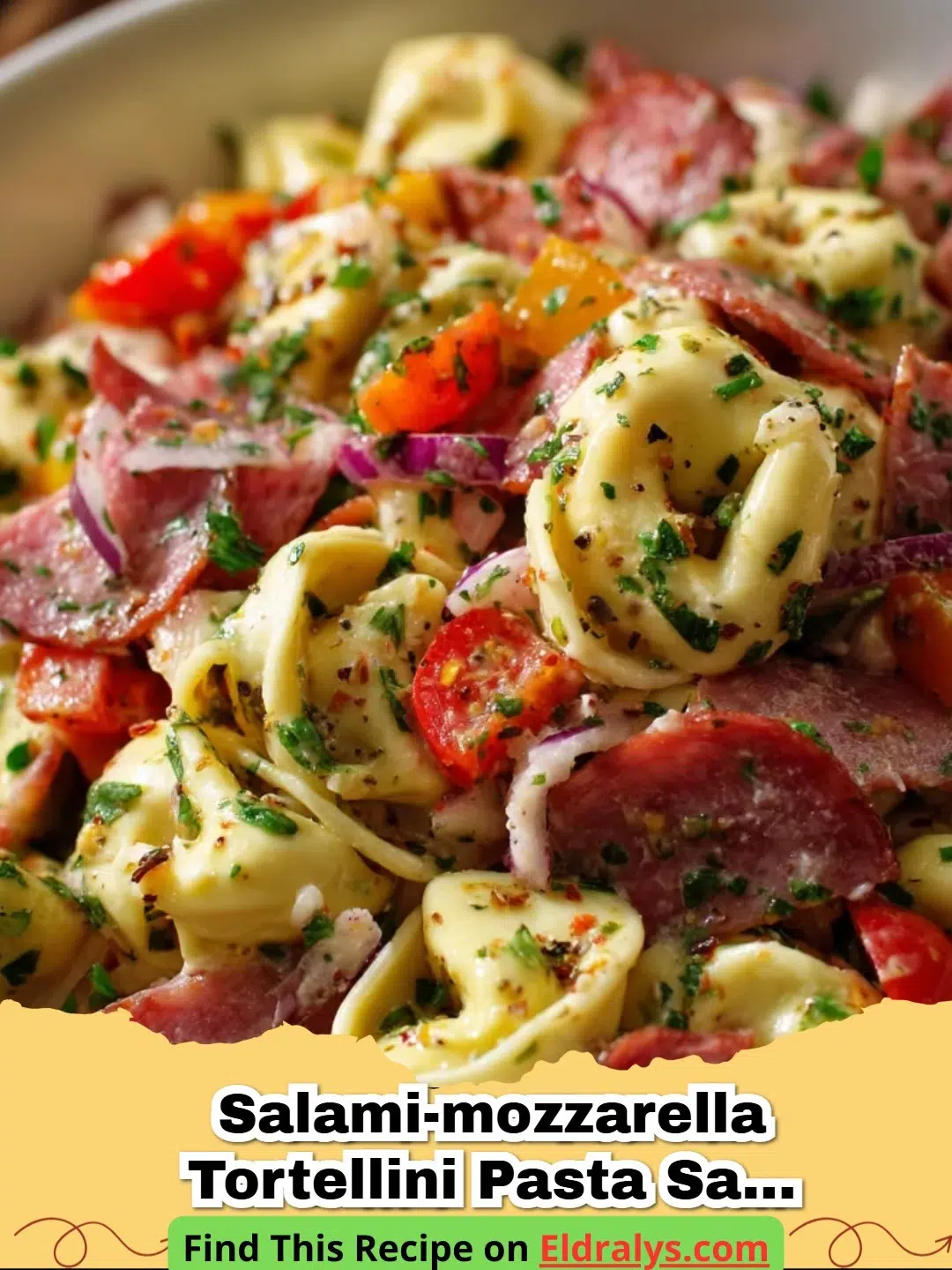 Salami-Mozzarella Tortellini Pasta Salad Recipe & Tips - A colorful Salami-Mozzarella Tortellini Pasta Salad in a large white bowl on a wooden table.
