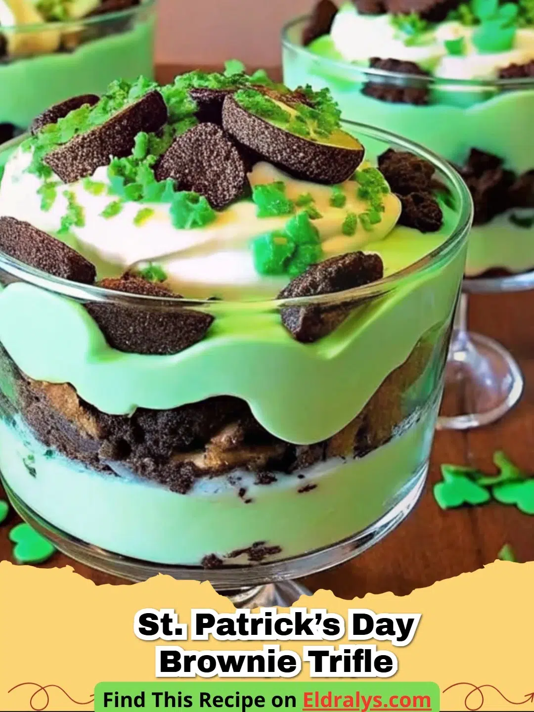 A tall glass trifle bowl filled with layers of St. Patrick’s Day Brownie Trifle, showing green and brown layers.