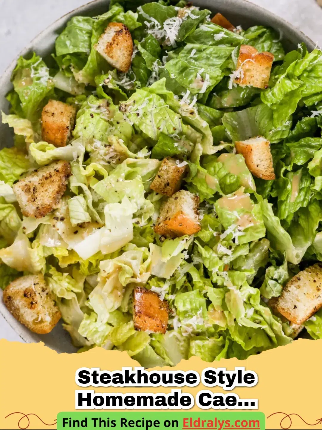 A close up shot of a Steakhouse Style Homemade Caesar salad with shaved parmesan and croutons.